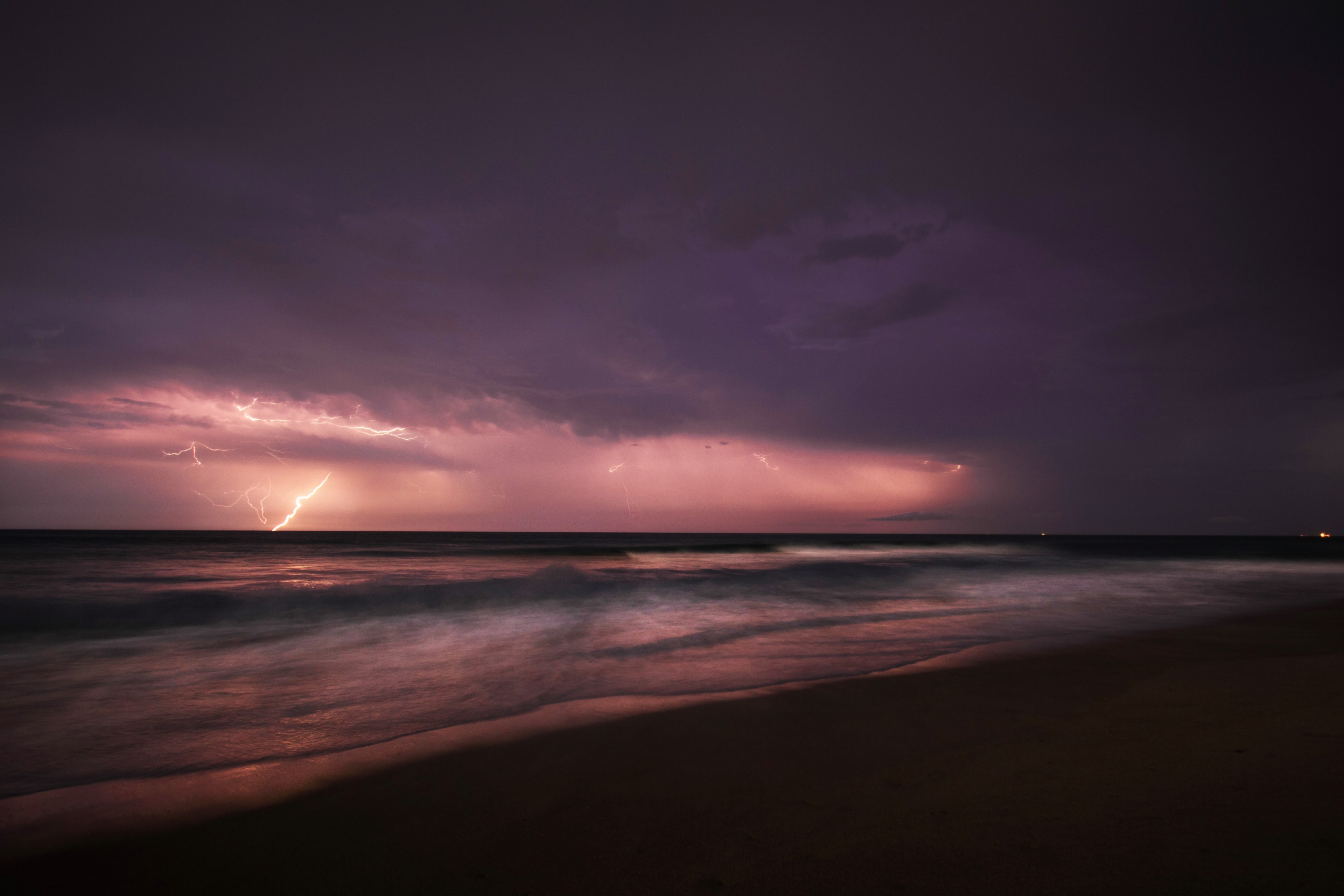 a bolt of lightning erupts from the clouds during a purple sunset over the southern shores, lightning crashes 4k, HD Wallpaper
