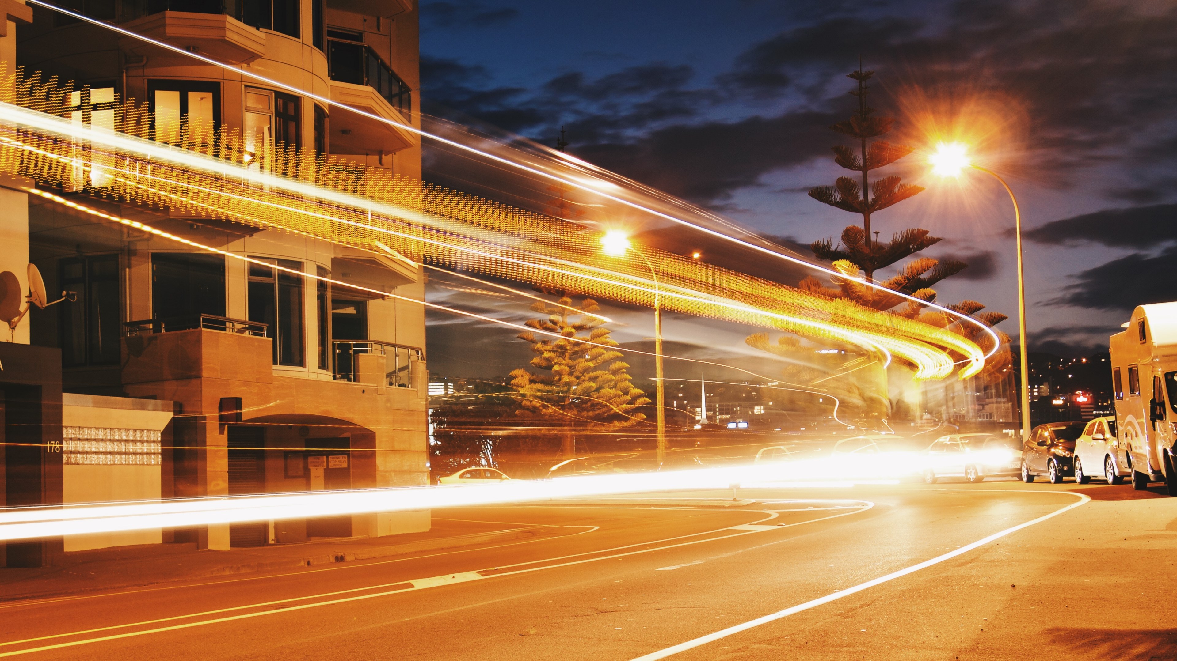 a vivid and bright shot of street lights with light trails from a traffic timelapse, streetlights and traffic light trails 4k, HD Wallpaper