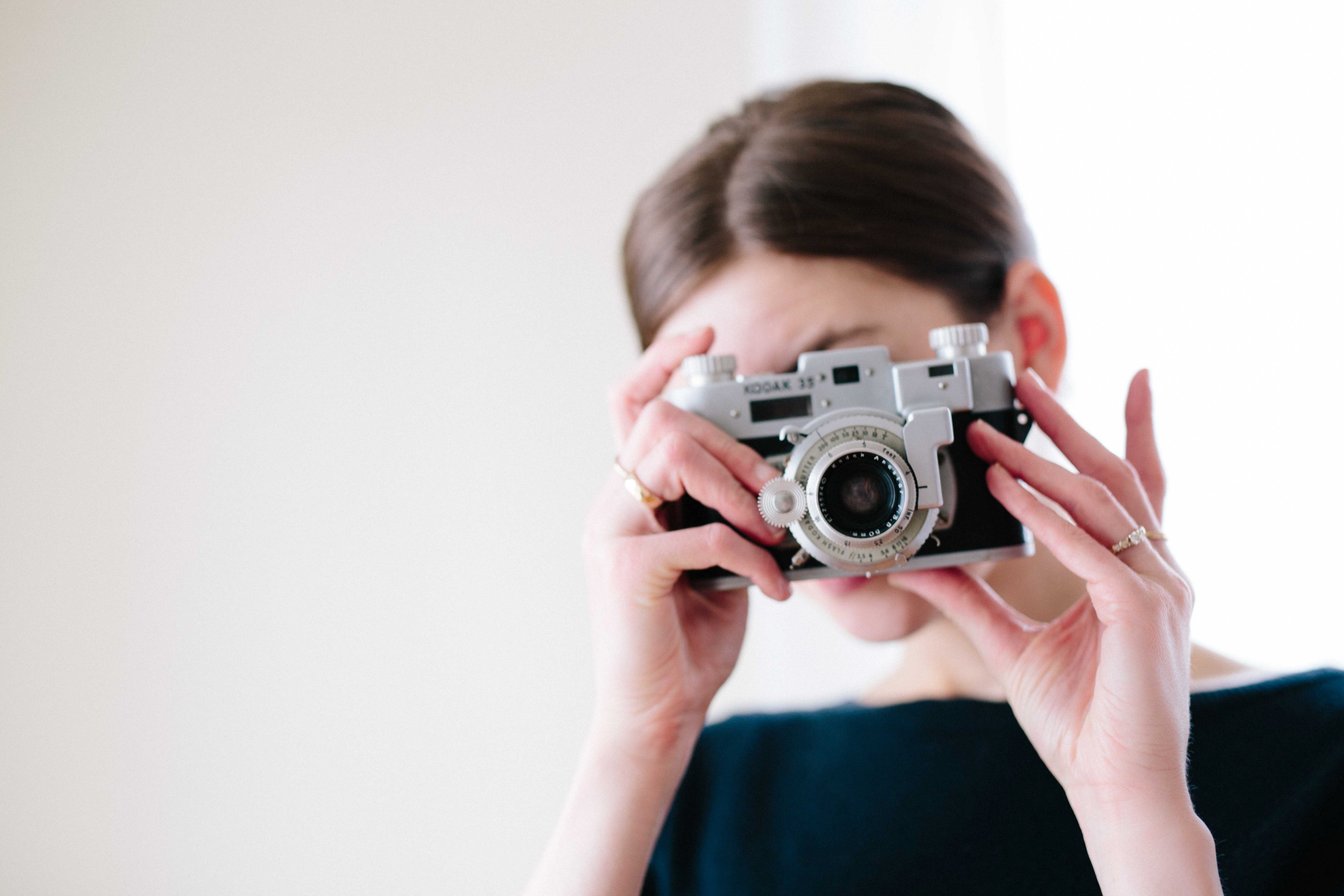 a woman taking a photo with a vintage kodak camera, kodak life 4k, HD Wallpaper