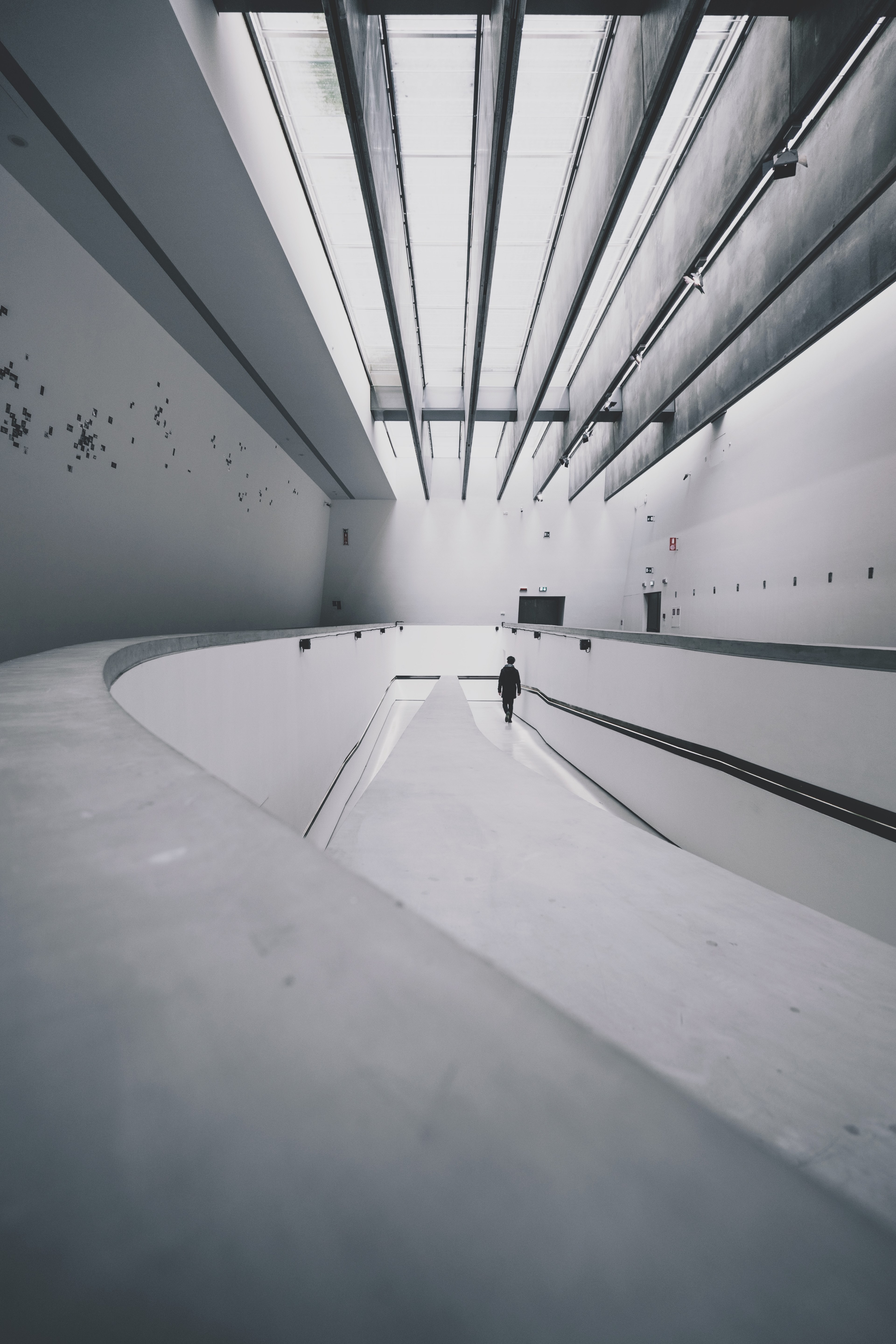 a distant shot of a lone person in a large white concrete building, lone person and skylight 4k, Phone HD Wallpaper