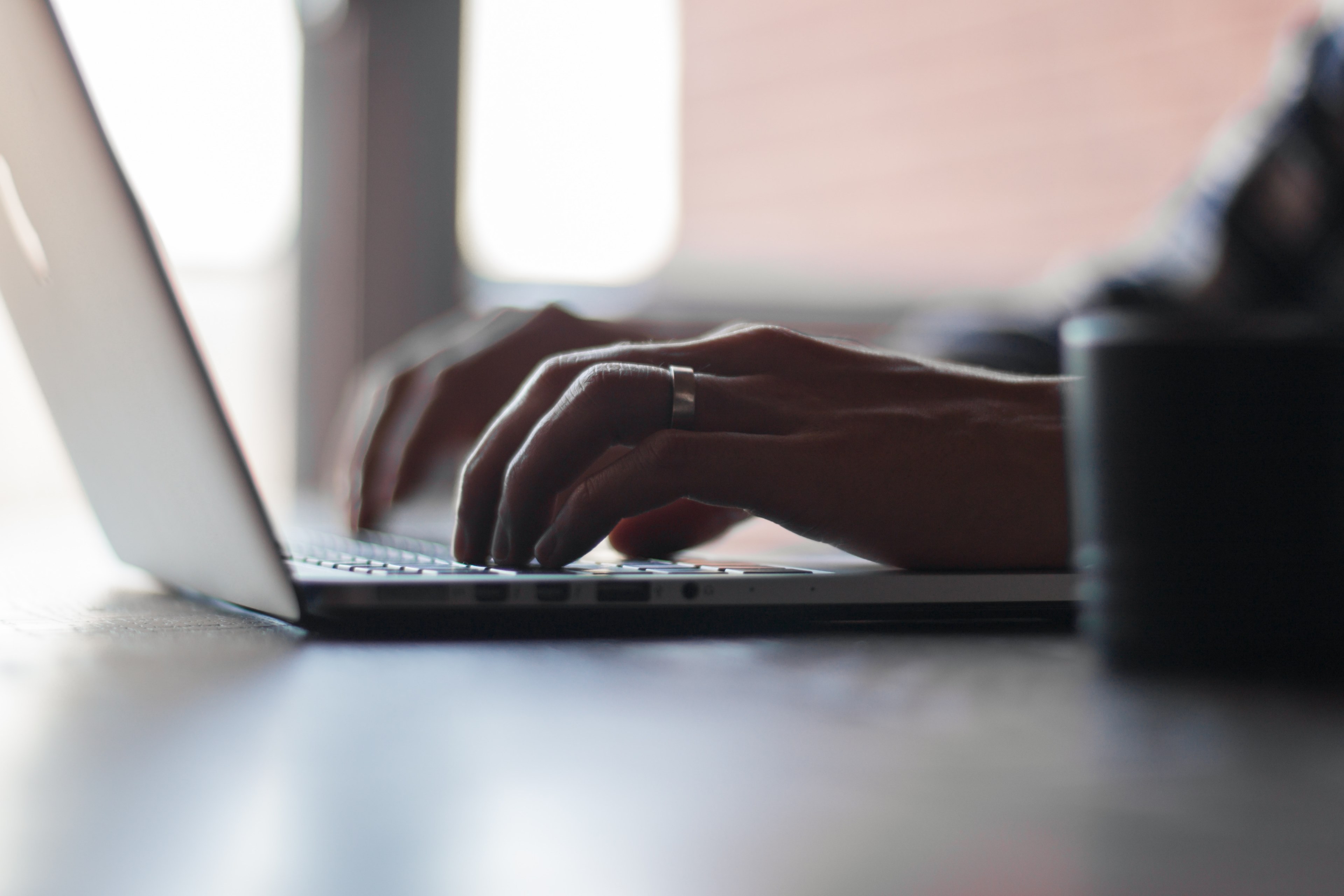 a typing bloggers hand with a ring on a computer mac working online and coding in an office, _typing on a mac 4k, HD Wallpaper