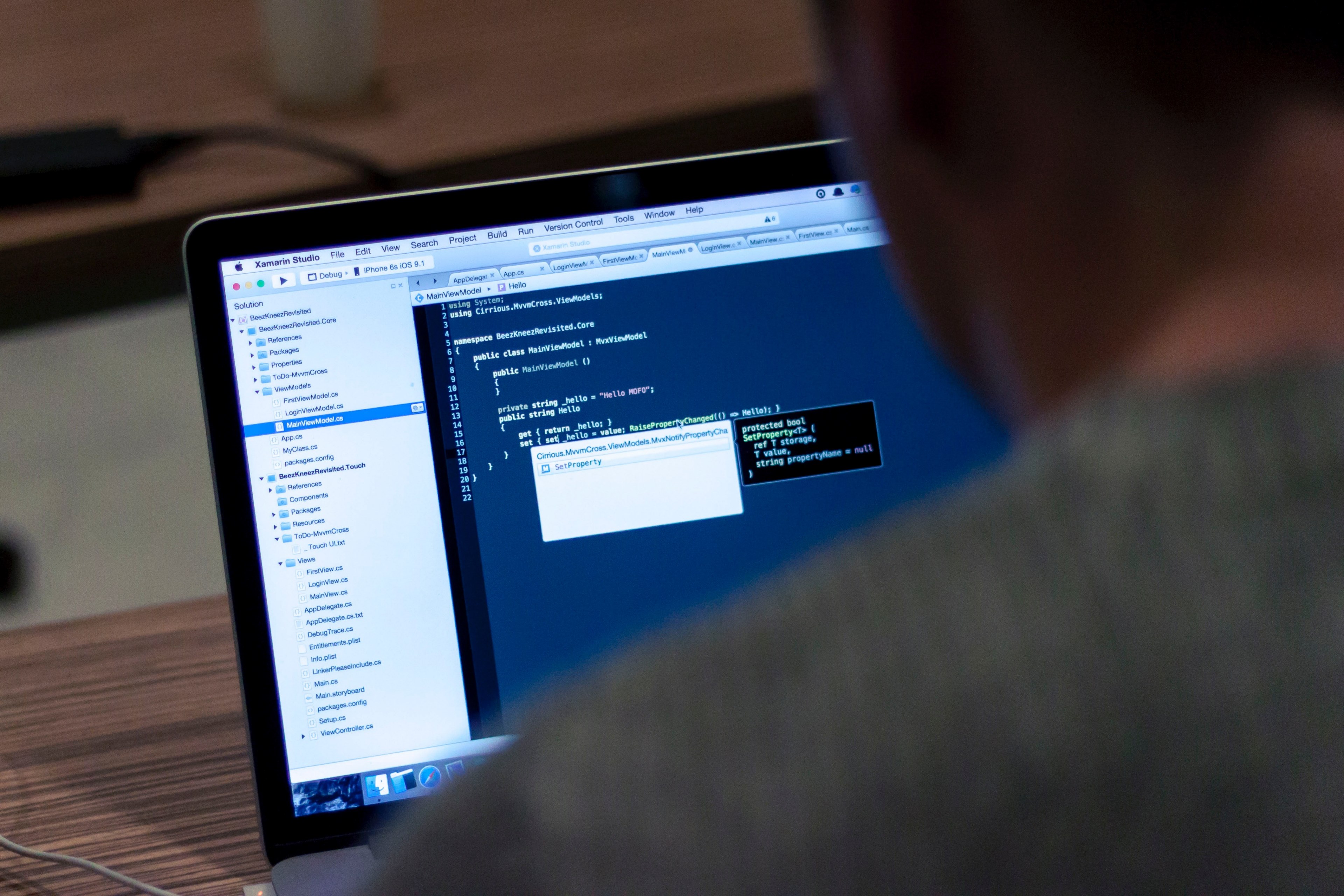 an over the shoulder shot of a person writing code on a laptop, laptop coding programs 4k, HD Wallpaper