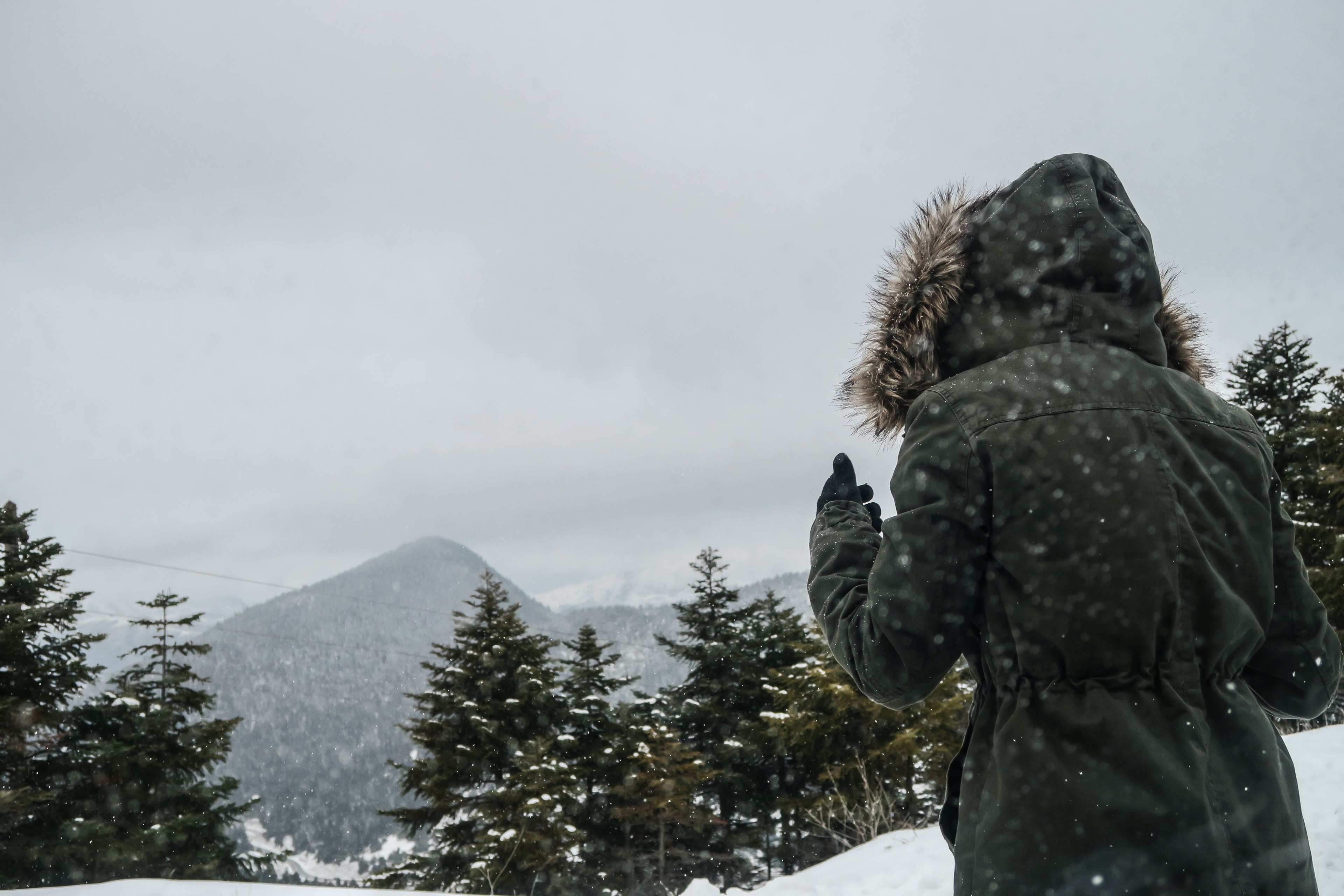 a person wearing a parka and walking through the snowy mountains in kalavryta greece, greece winter mountains 4k, HD Wallpaper