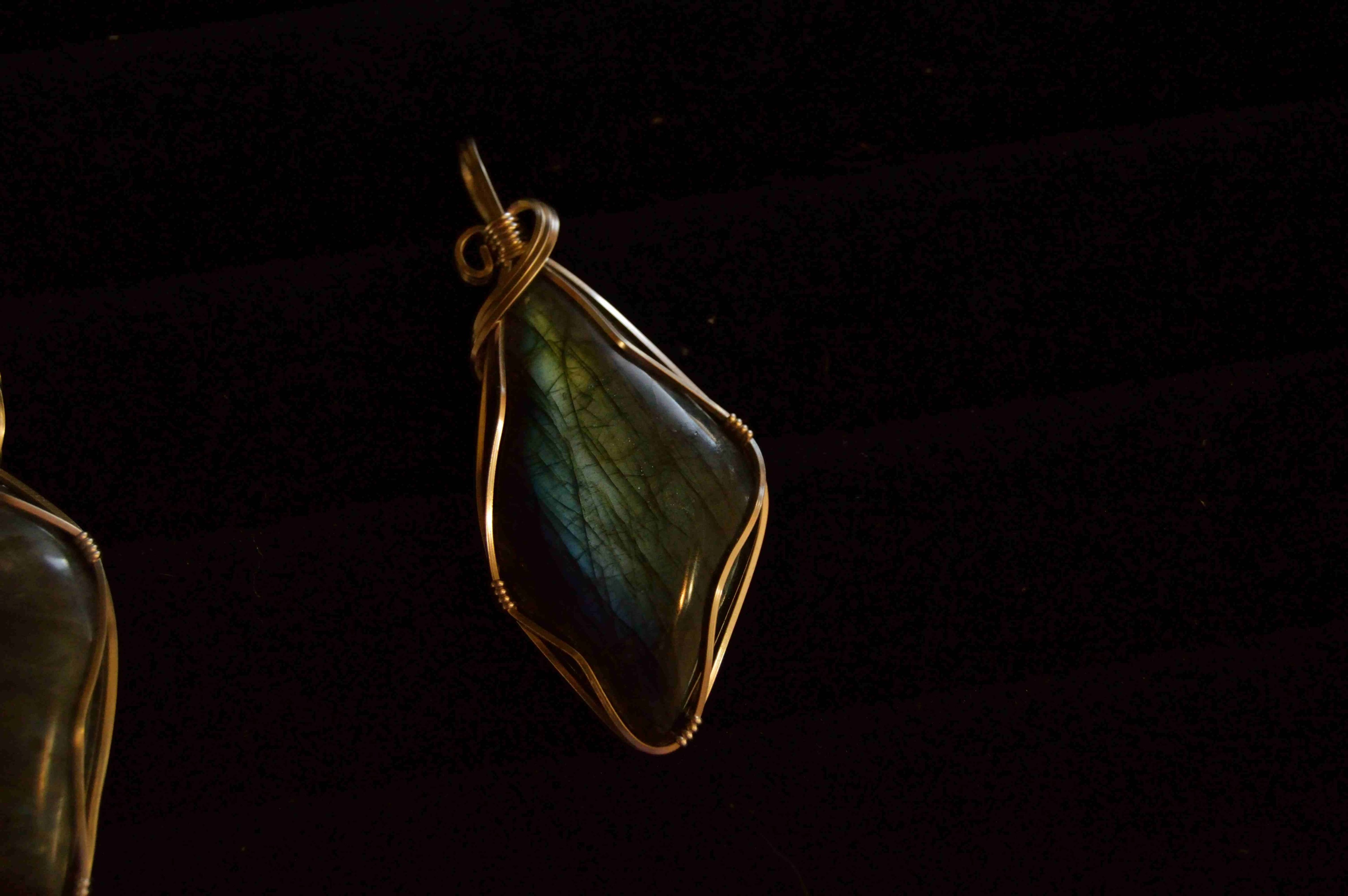 a gemstone pendant wrapped in a copper wire against a black background, twisted wire jewelry 4k, HD Wallpaper