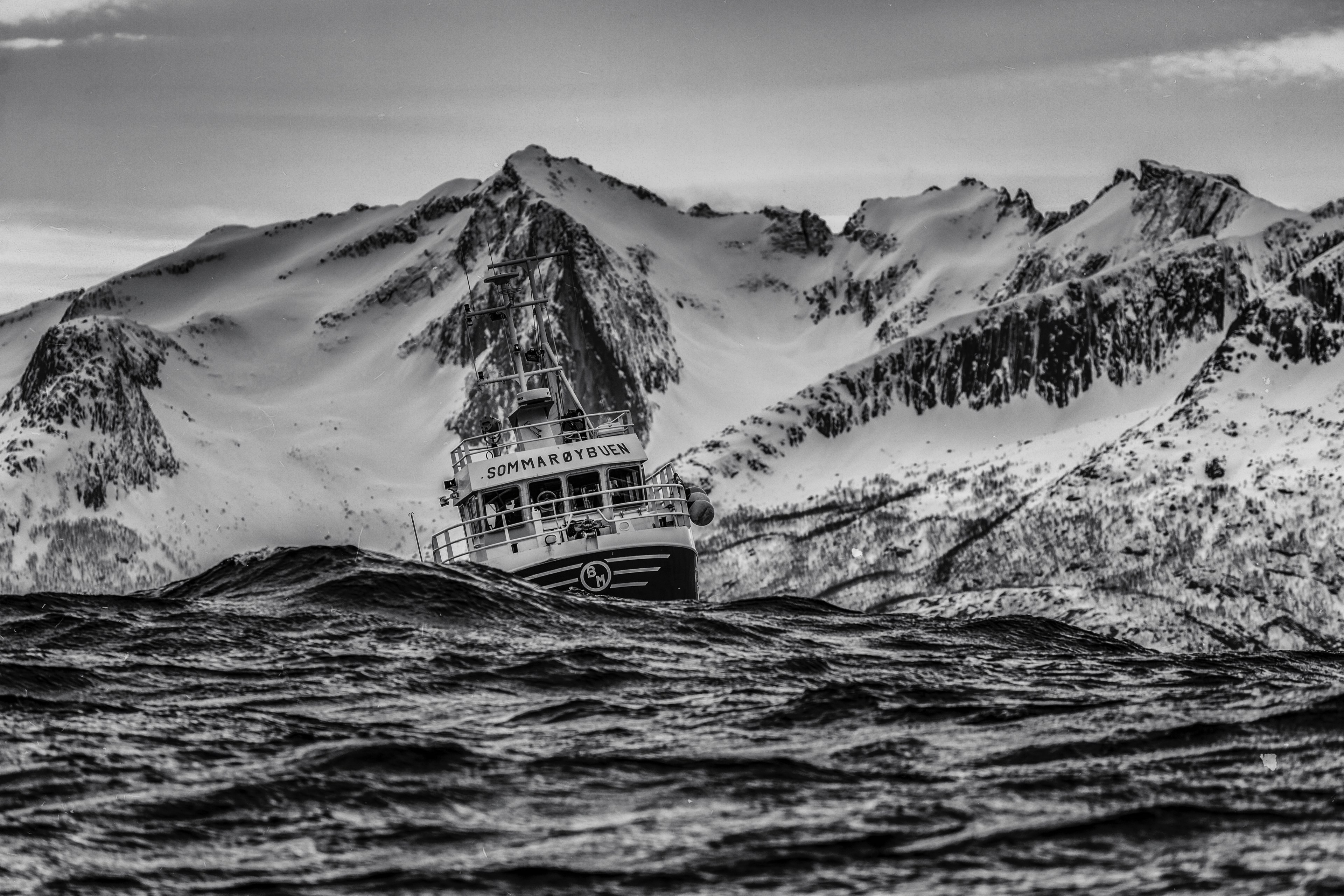 black and white shot of ship sailing in rough waters with snowy mountains behind, ship in rough waters 4k, HD Wallpaper