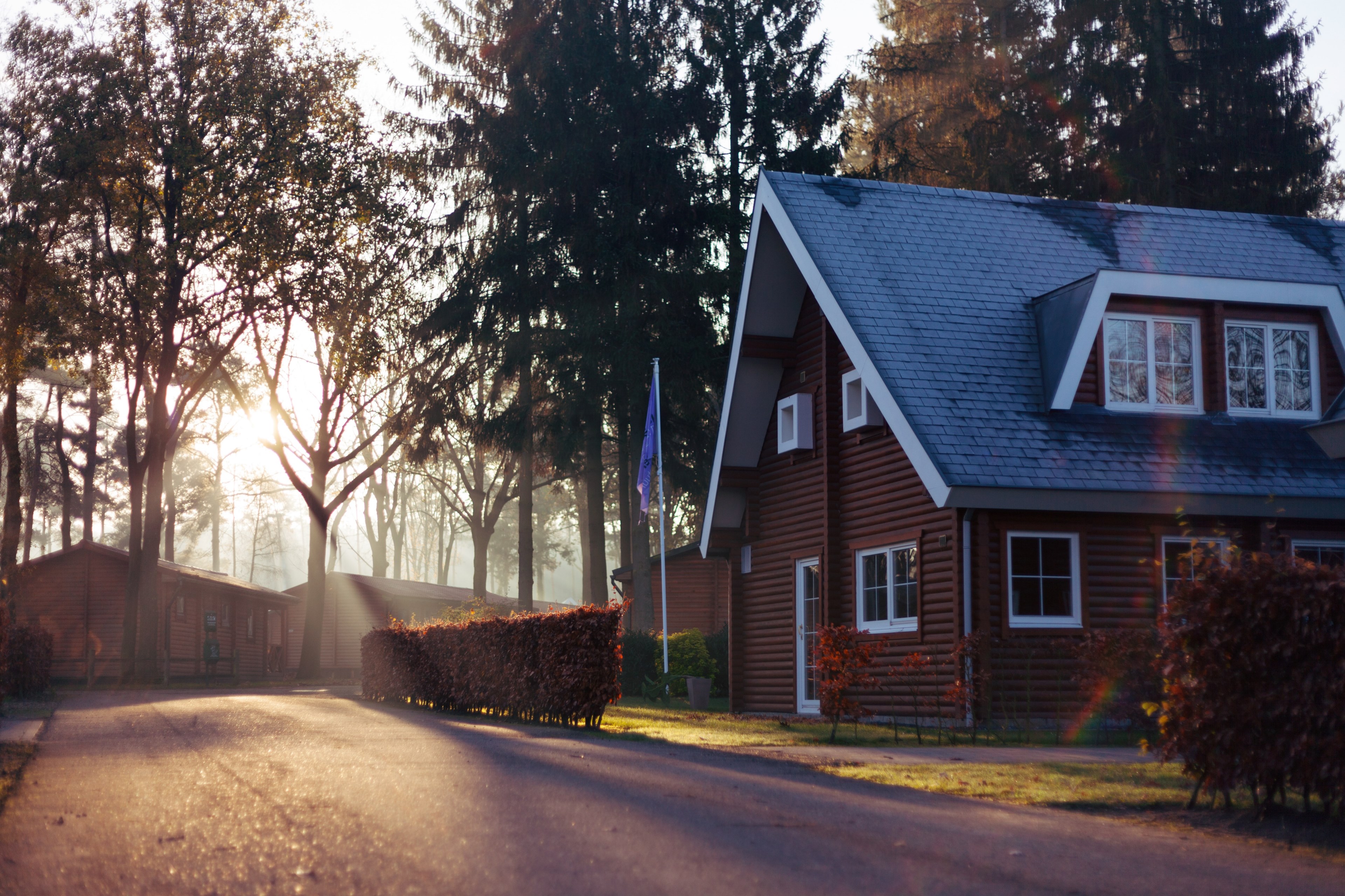 brown house with blue roof in front of trees with rays of the setting sun streaming through them, brown house blue roof 4k, HD Wallpaper