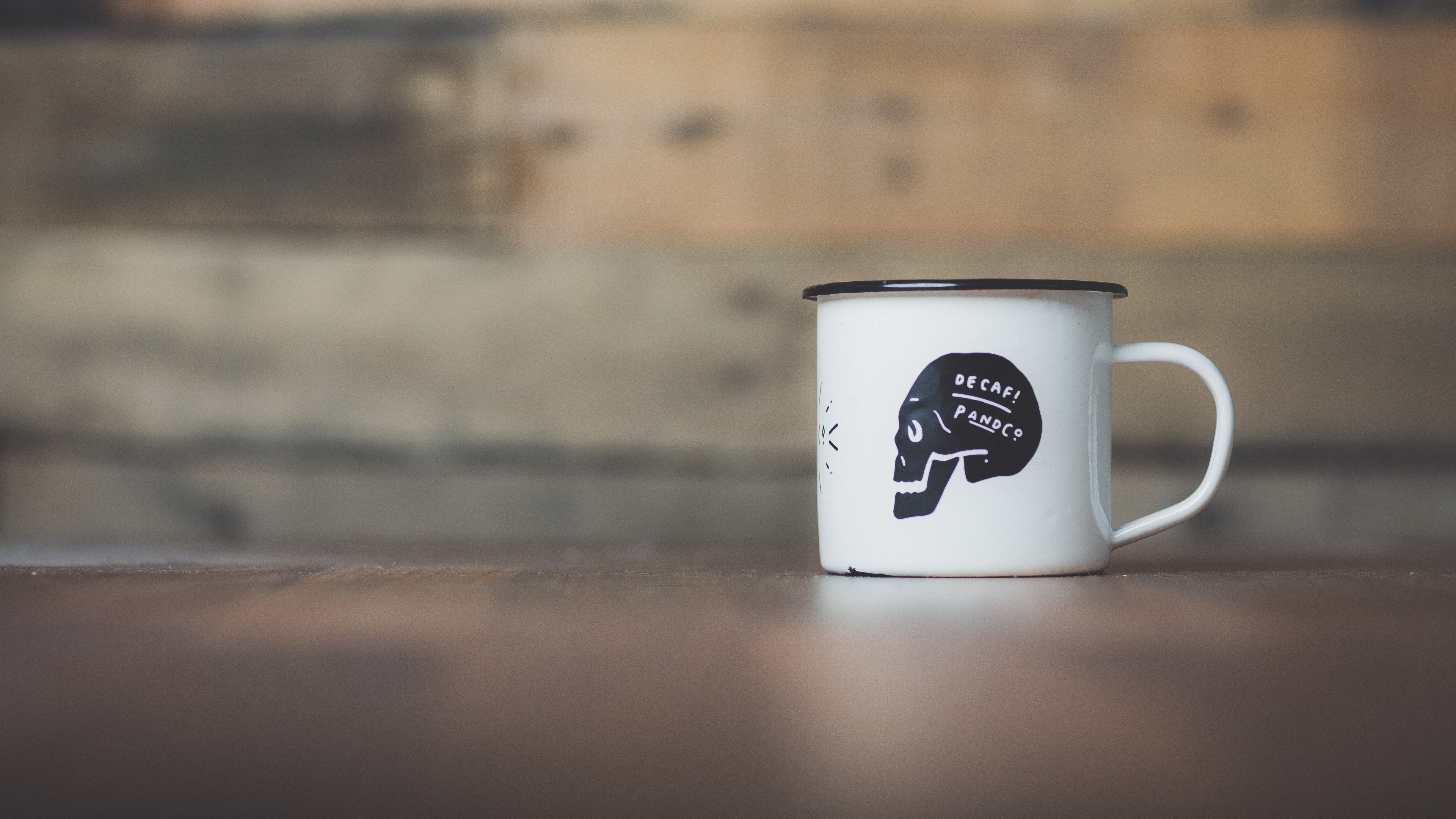tin white mug with black skull reading decaf on it in front of wooden background, coffee mug 4k, HD Wallpaper