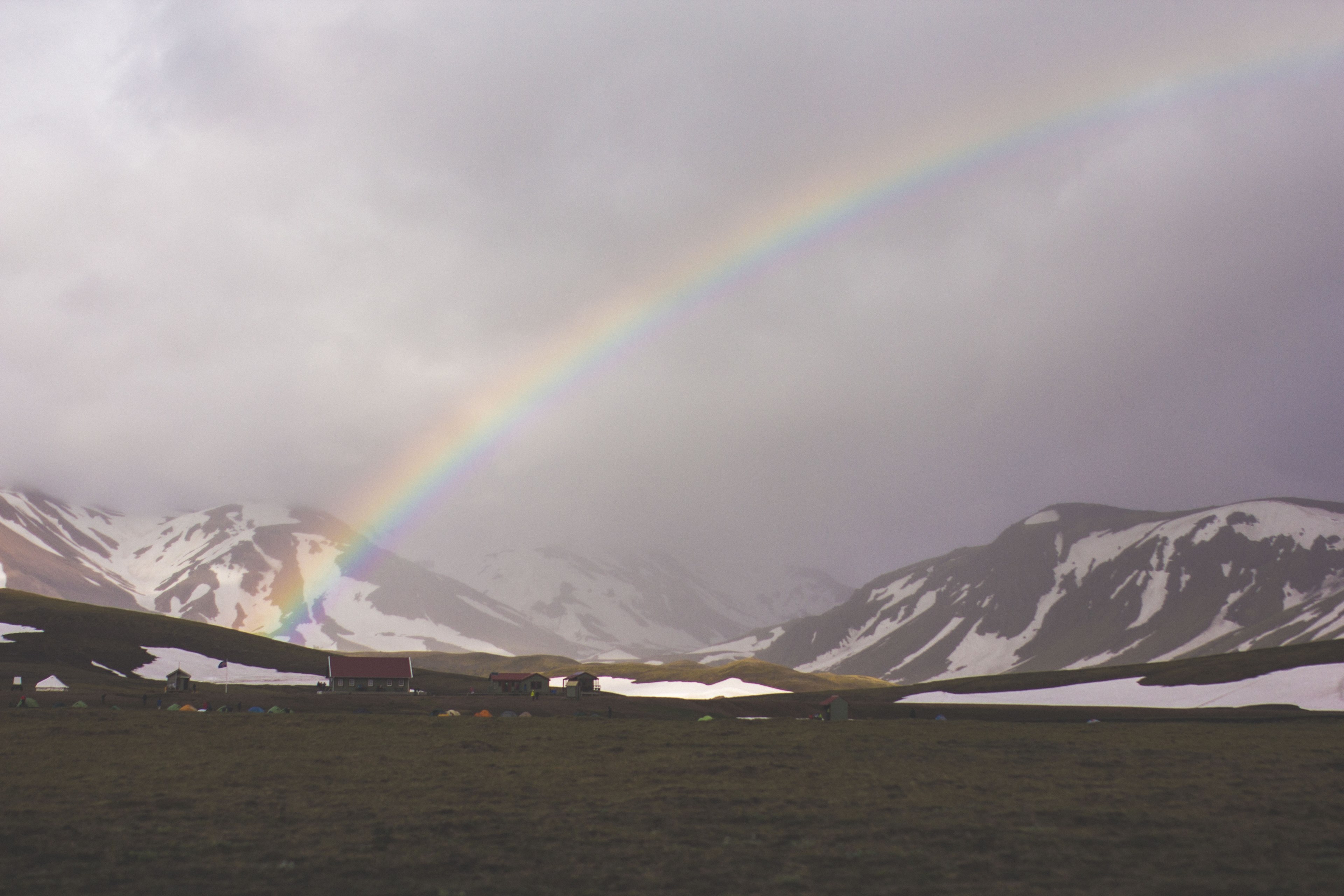 a landscape of rainbow over a field with a view of mountains covered in snow, a rainbow going over a snowy mountain 4k, HD Wallpaper