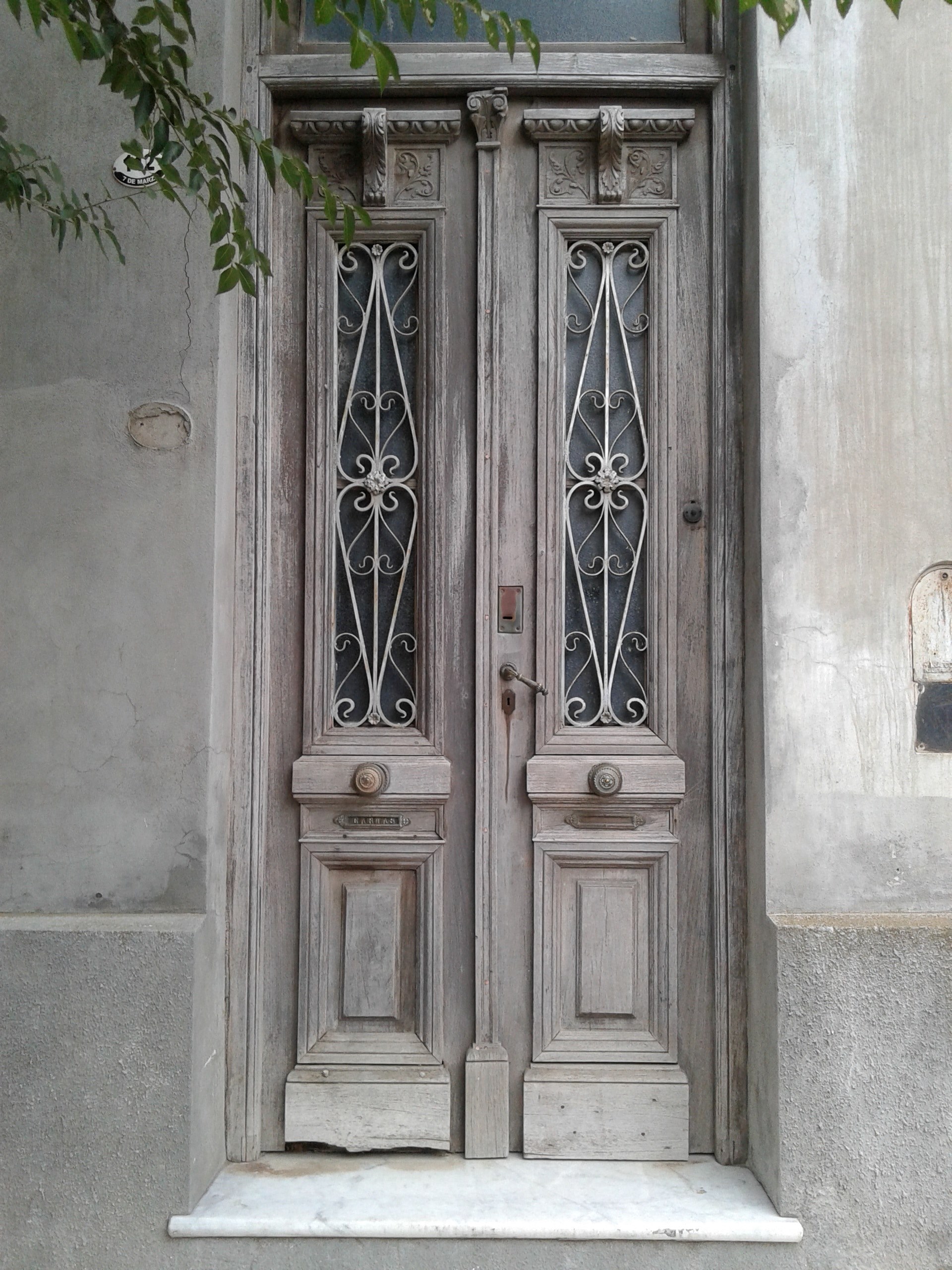 old vintage door with light wood and tall decorative glass windows on a tan building, visiting old cities 4k, Phone HD Wallpaper