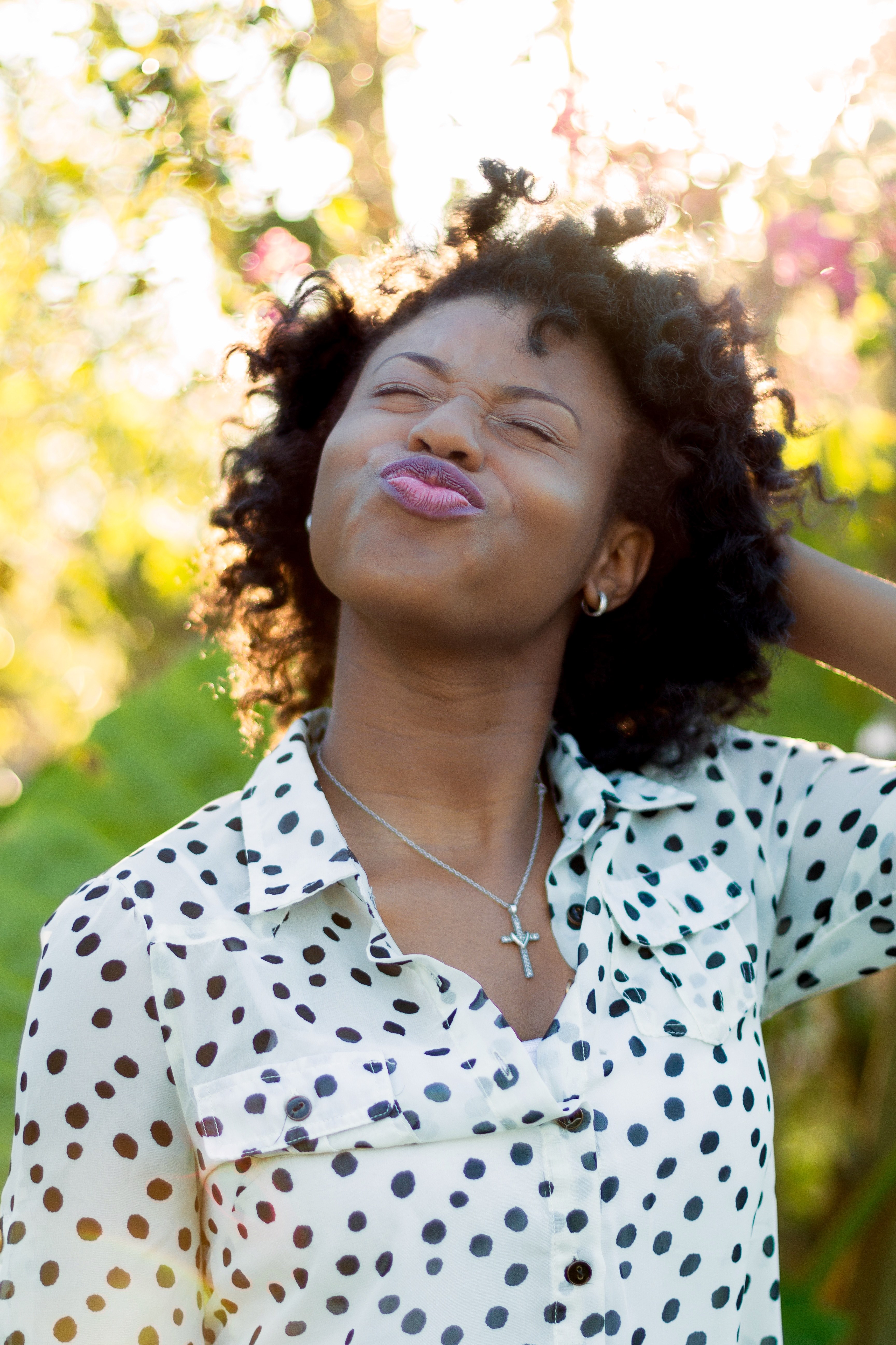 a woman with curly hair purses her lips and closes her eyes in the sunshine, black without apology 4k, Phone HD Wallpaper