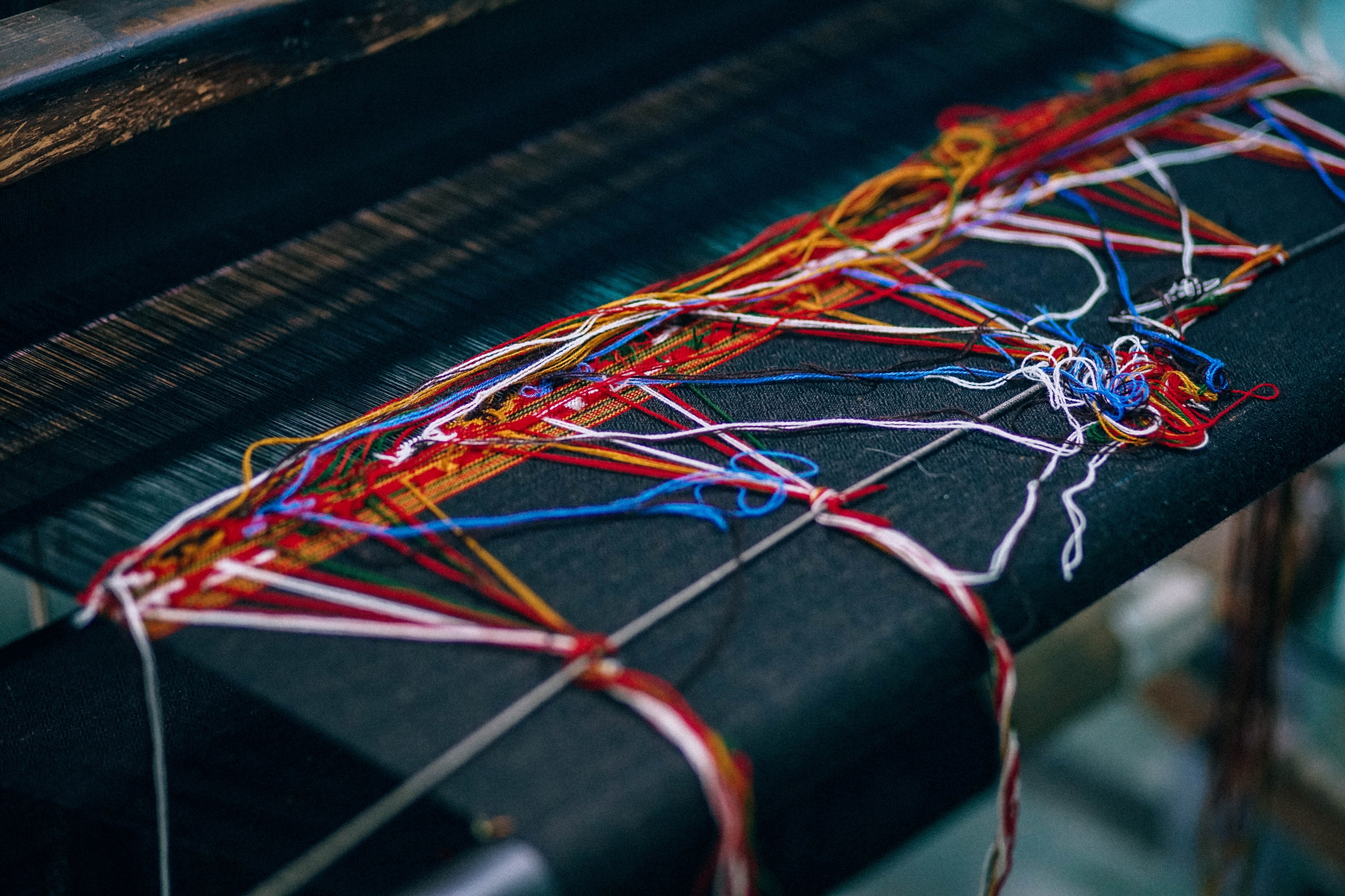 red white and blue sewing thread on a wooden desk at a factory, unfinished business 4k, HD Wallpaper