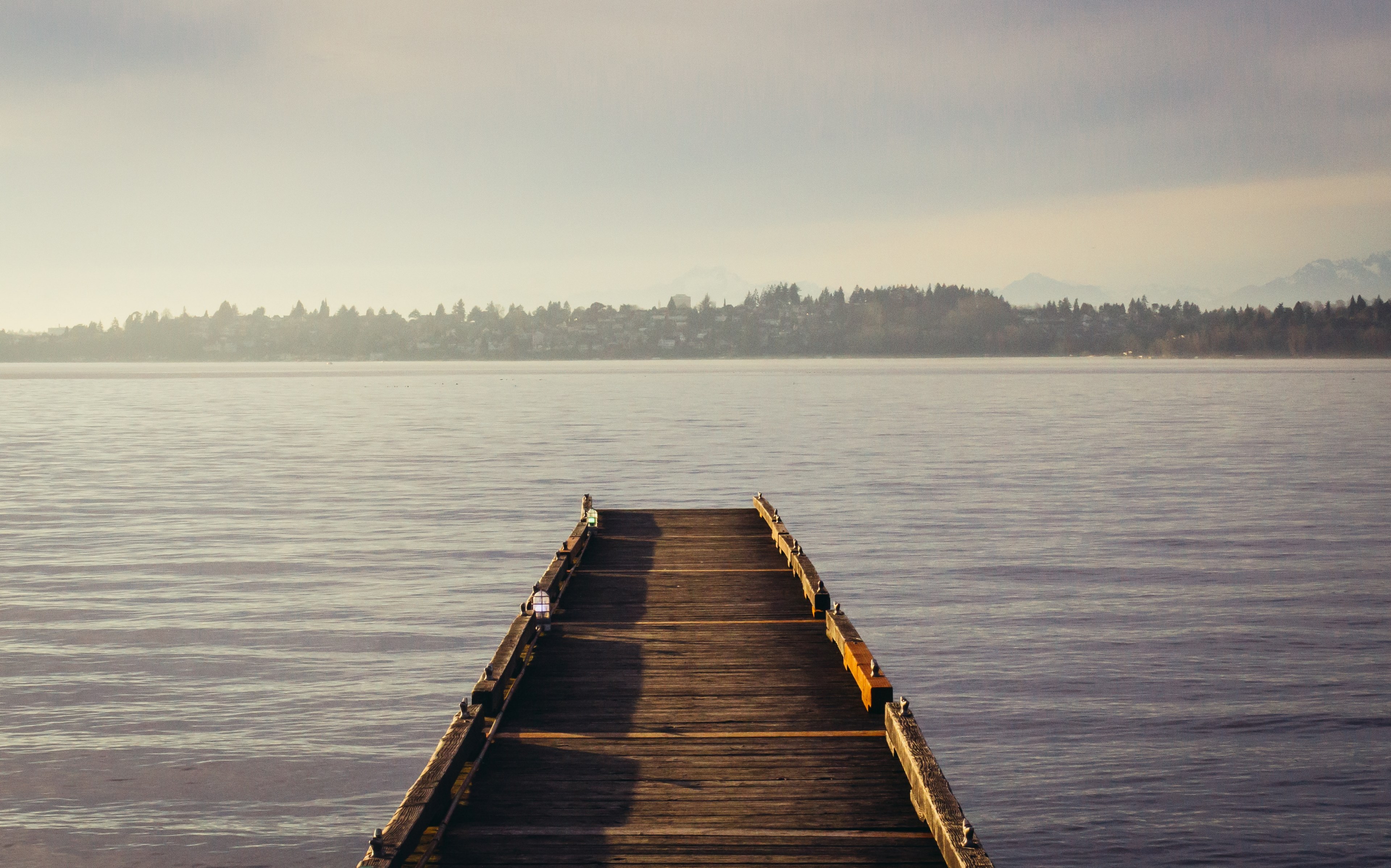 an empty wooden pier on a lake with a woody shore on the horizon, pier reaching out to the lake 4k, HD Wallpaper