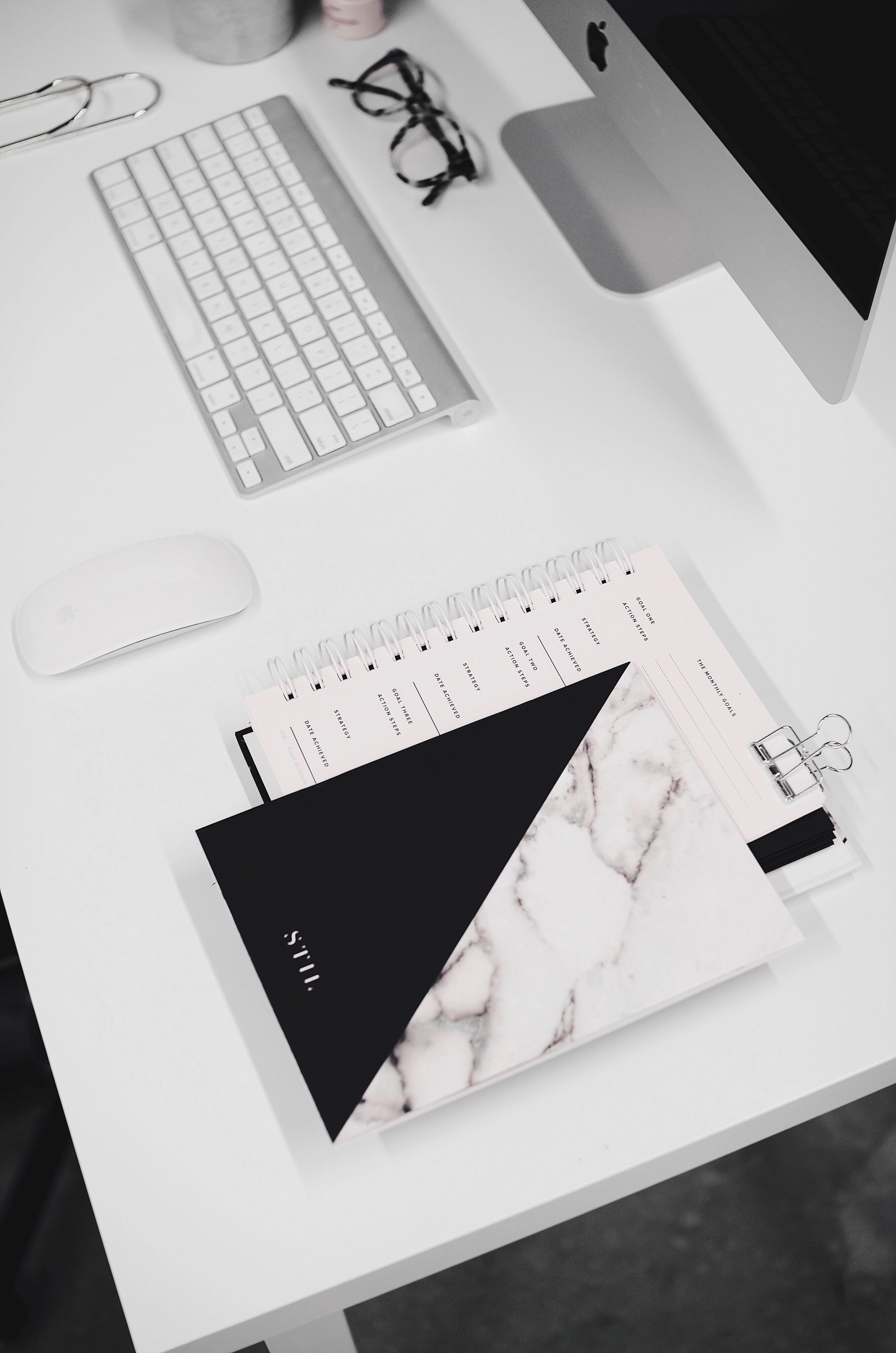 a spiral notebook and a book on a white desk with an imac, navy and marble journal 4k, Phone HD Wallpaper