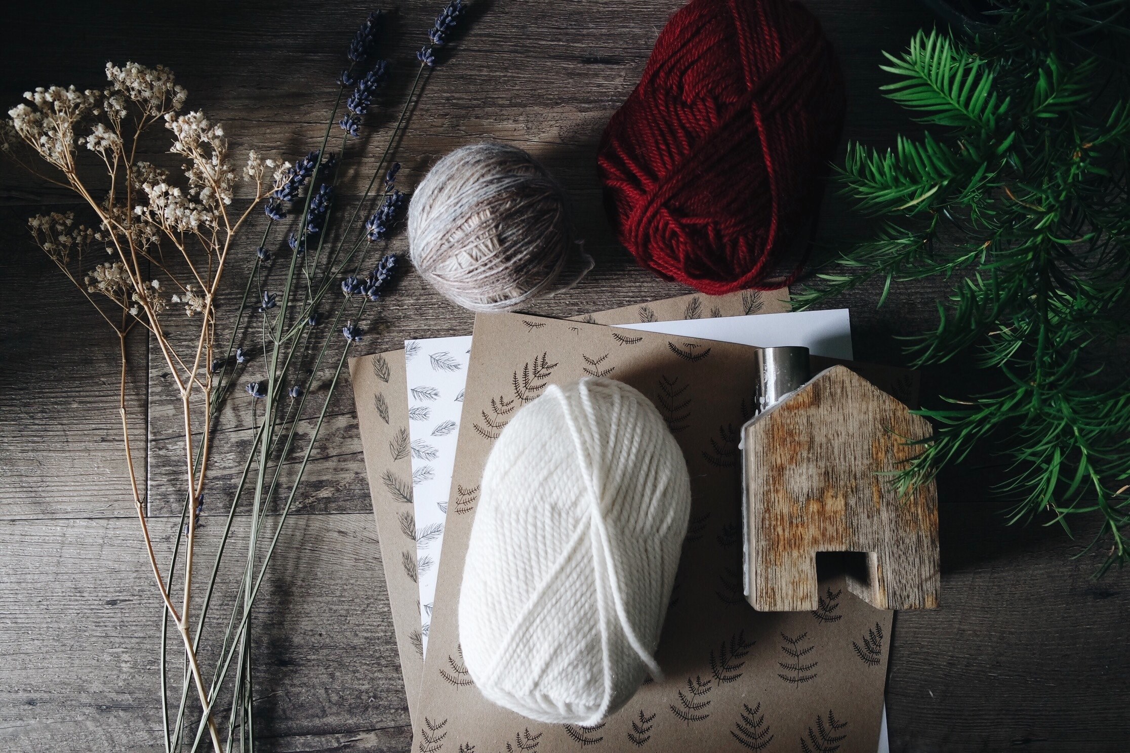 a bunch of flowering grasses next to a pine branchlet and three balls of yarn, flatlay with balls of yarn 4k, HD Wallpaper