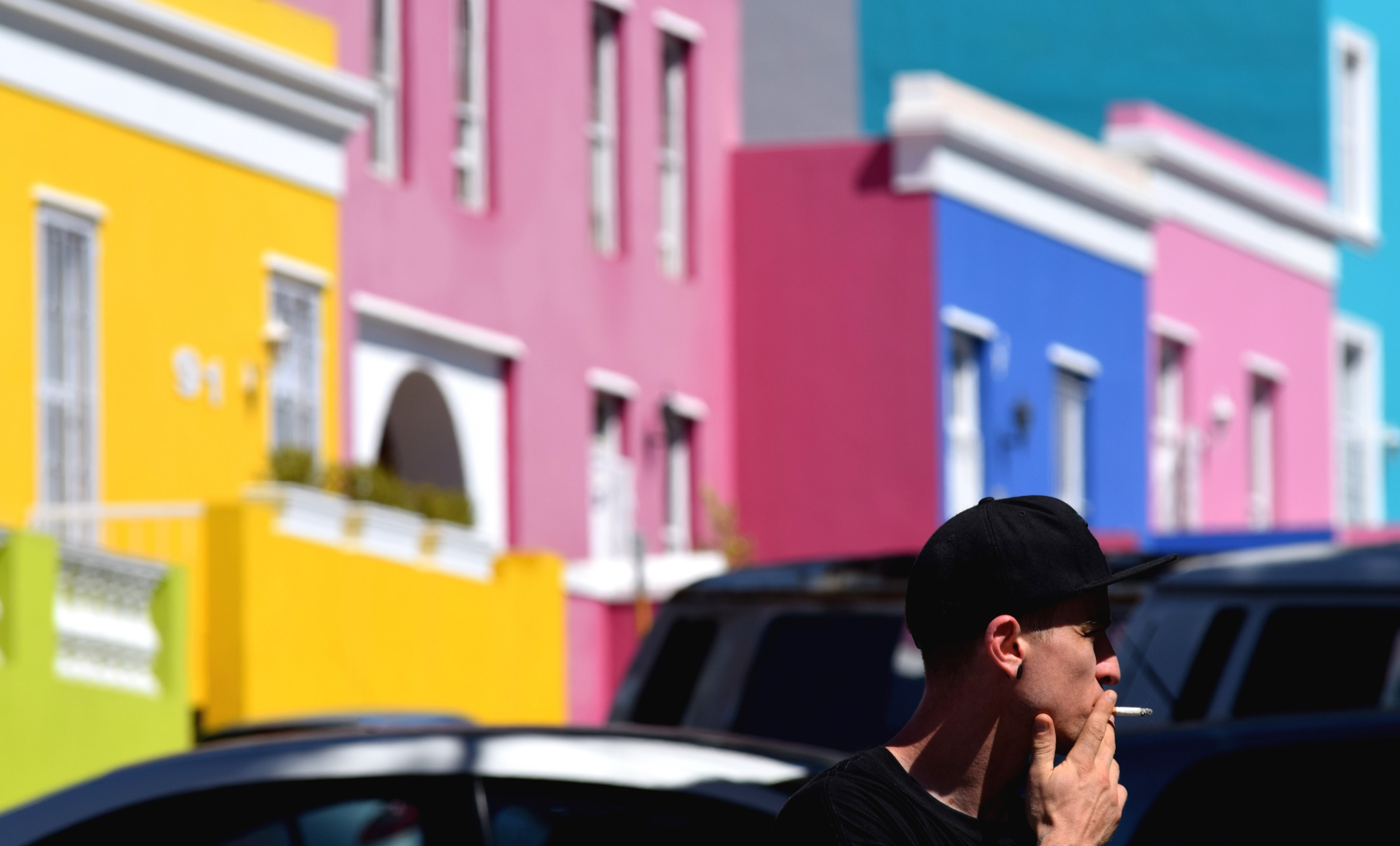 person smoking a cigarette near colorful bright buildings, bokaap drag 4k, HD Wallpaper