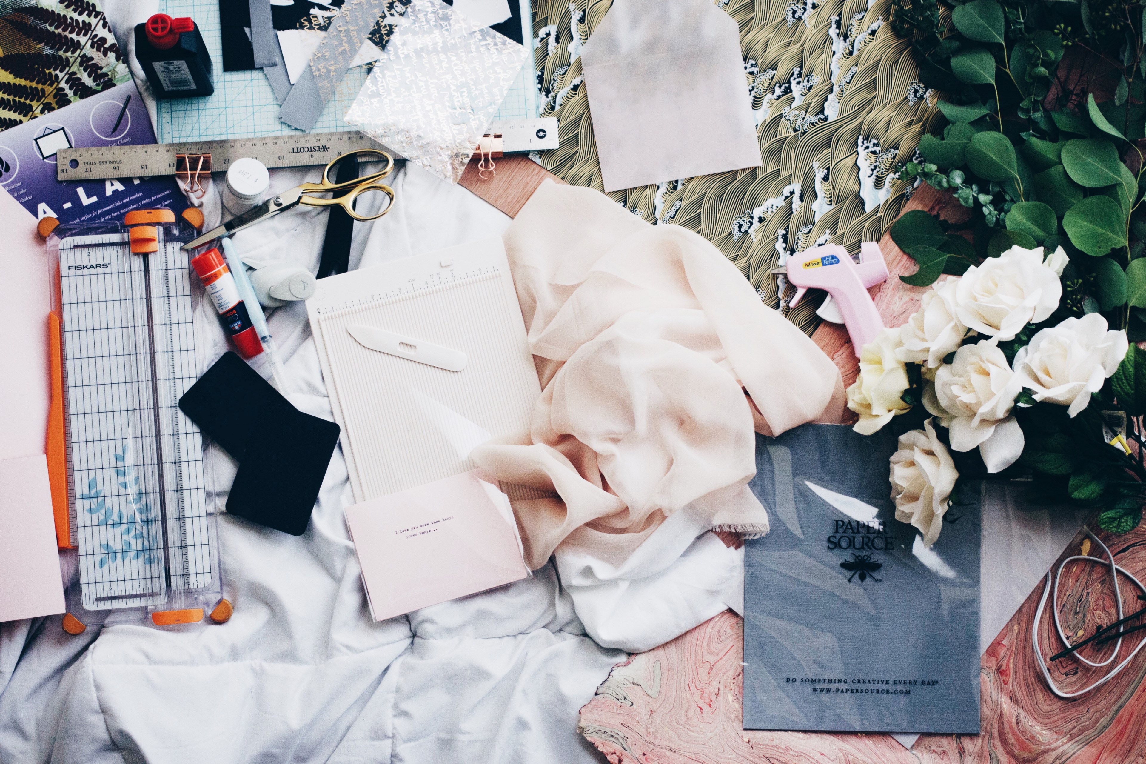 a flatlay with paper various office supplies and white roses on pieces of cloth, stationery and flowers flatlay 4k, HD Wallpaper