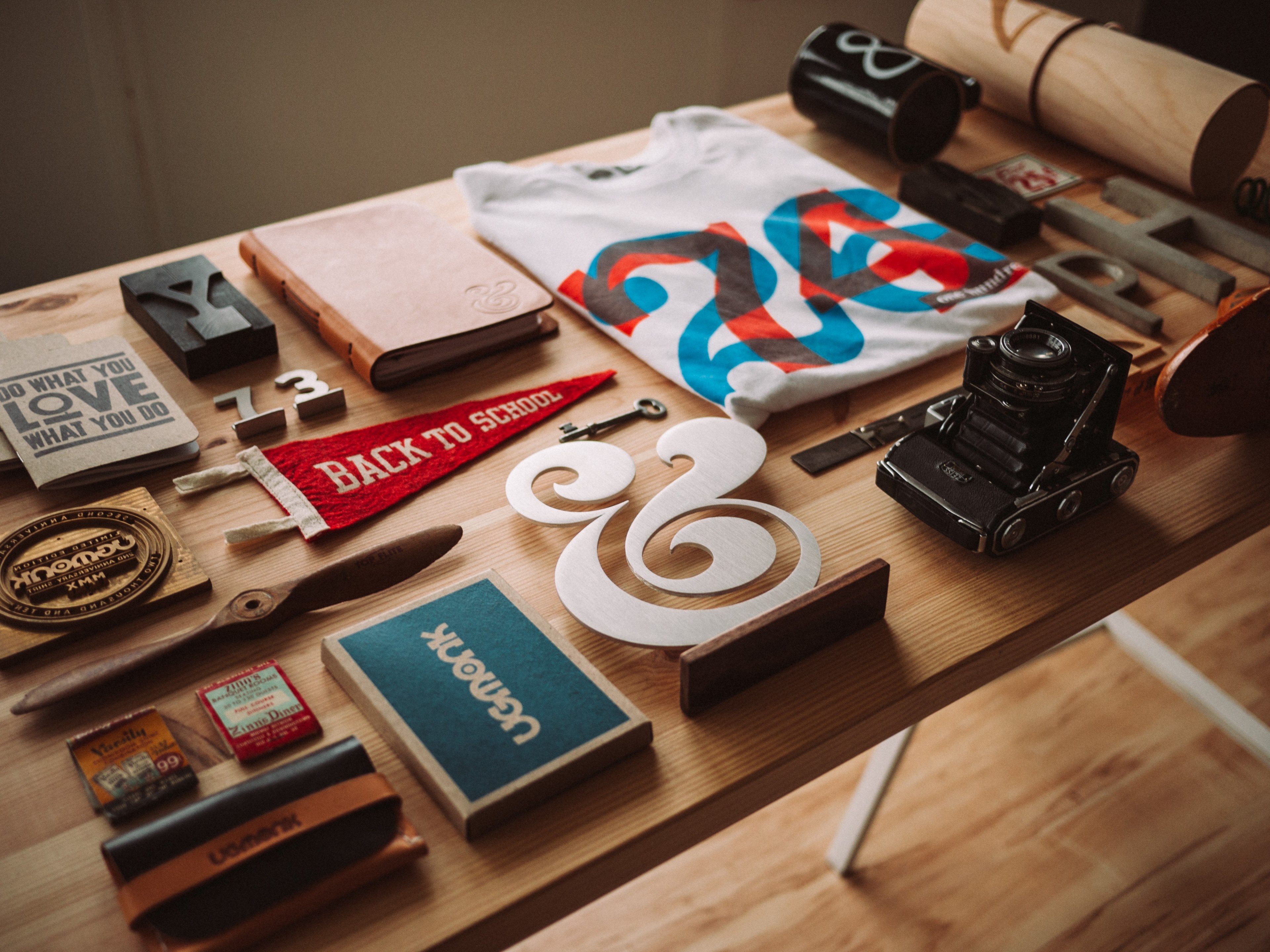 a flatlay with a t shirt a camera a notebook and various trinkets on a table, artistic flatlay 4k, HD Wallpaper