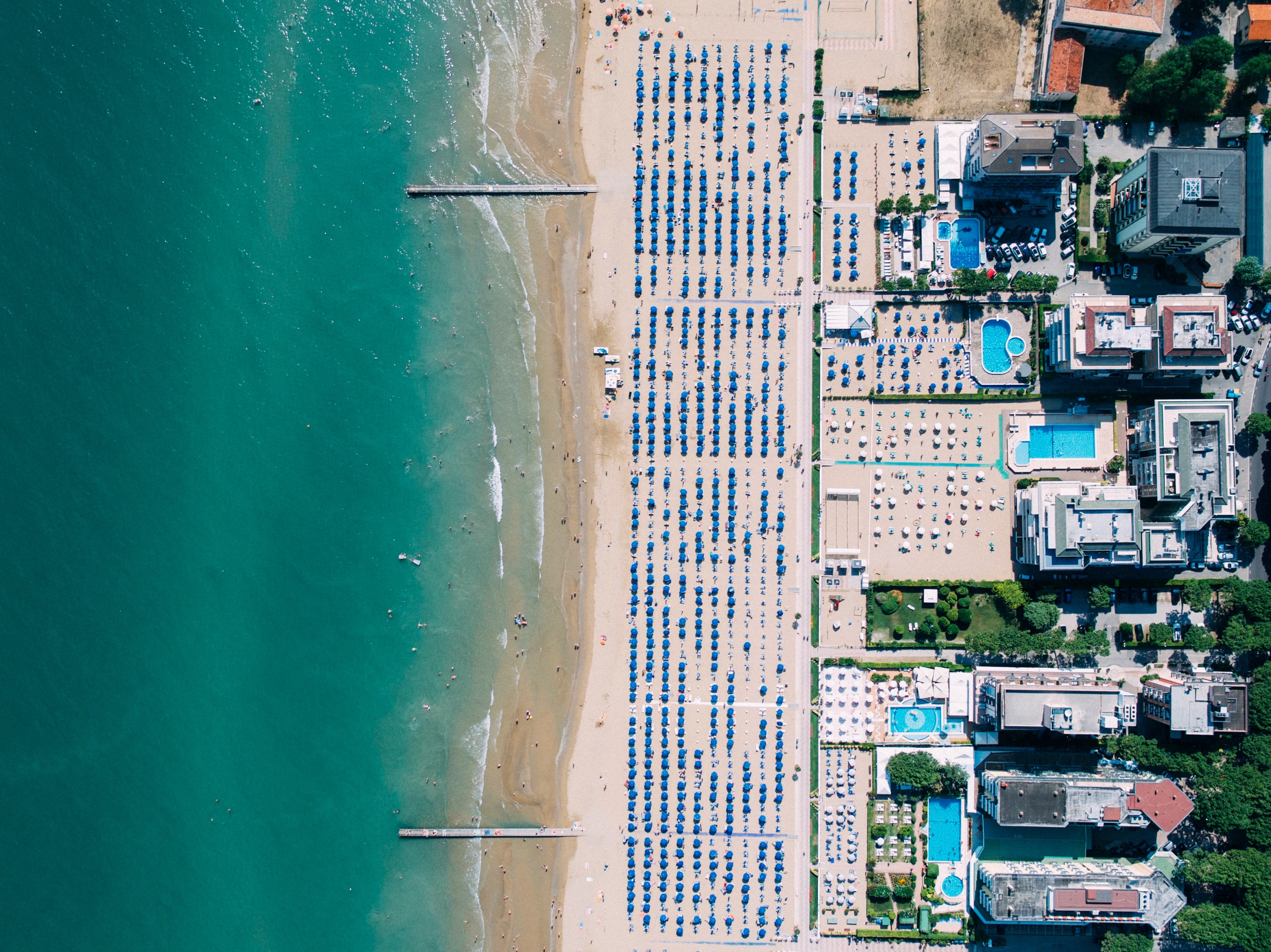 drone aerial view of coastal resorts and an ocean sand beach in lido di jesolo, beachday 4k, HD Wallpaper