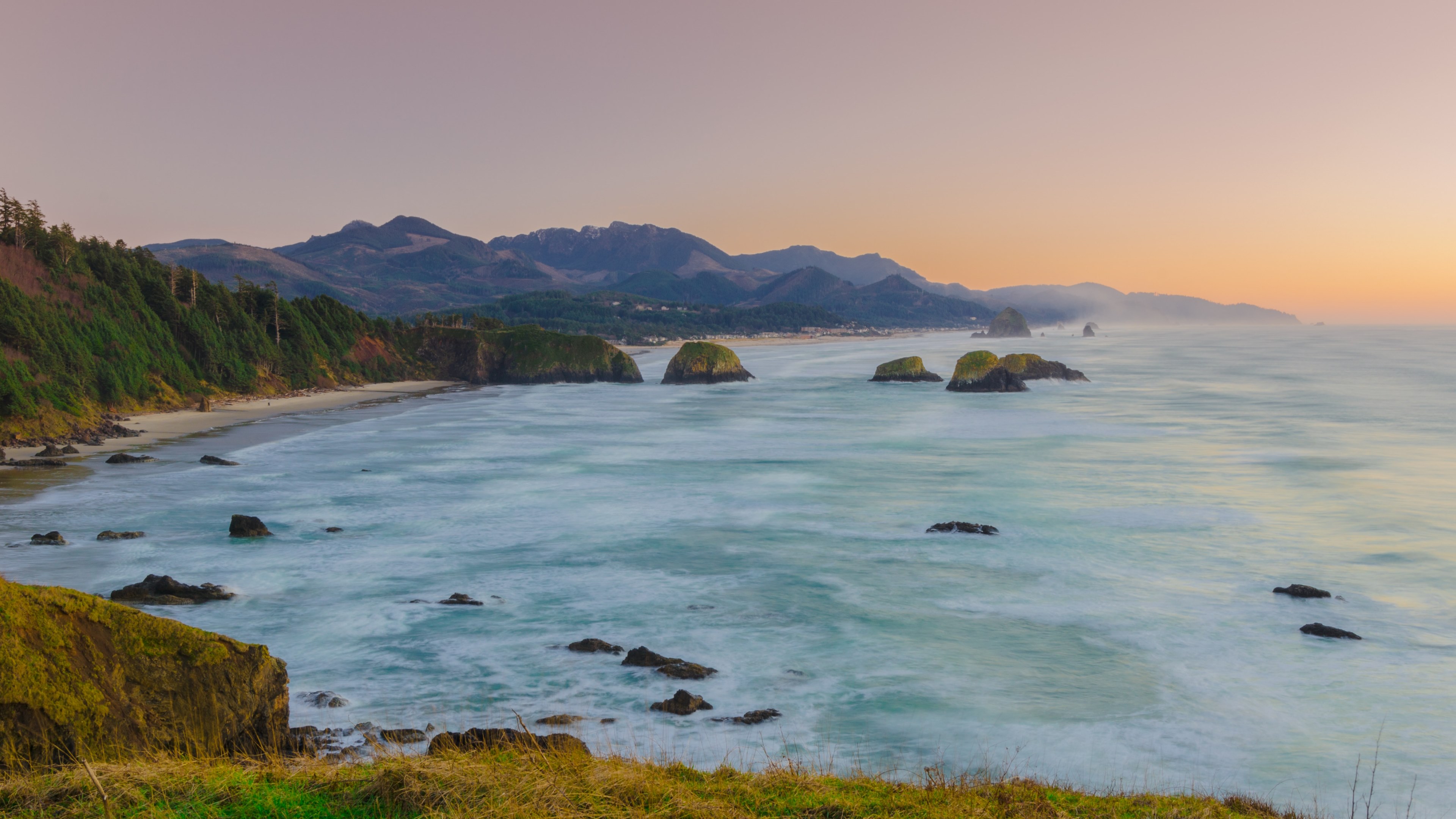 ocean washing on a sandy beach with green cliffs in ecola state park at sunset, shoreline at sunset 4k, HD Wallpaper
