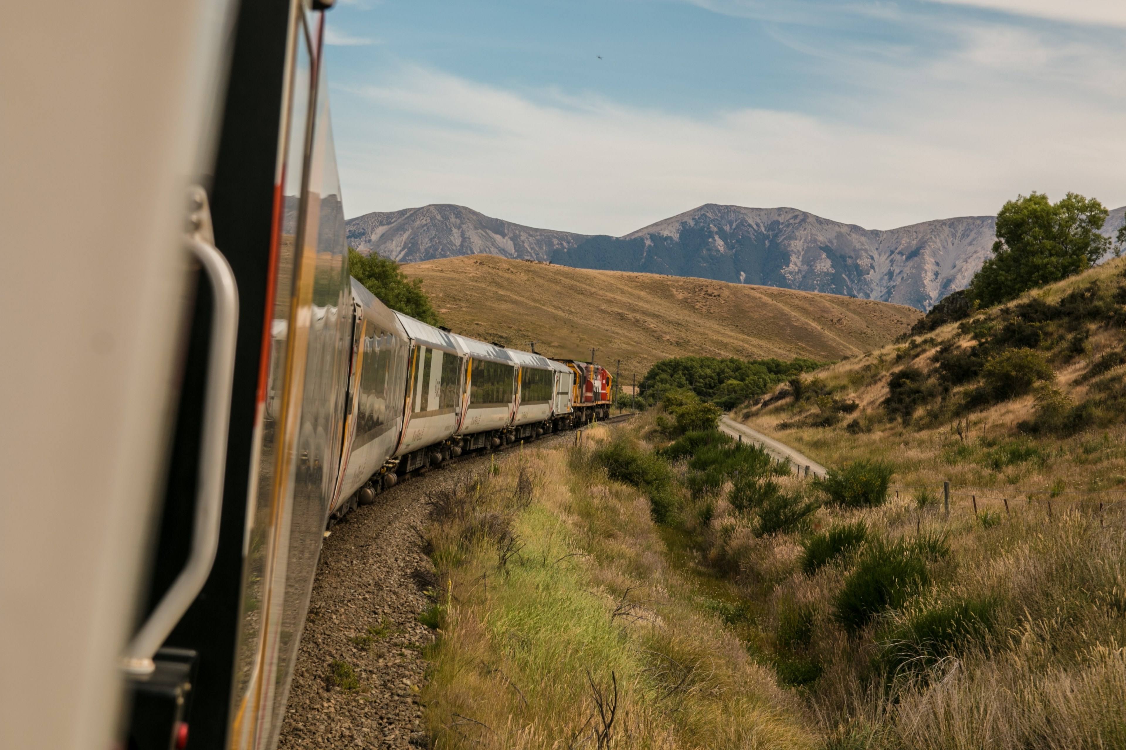 the cars of a train on a curve in the track running through the mountains, train cars in the mountains 4k, HD Wallpaper