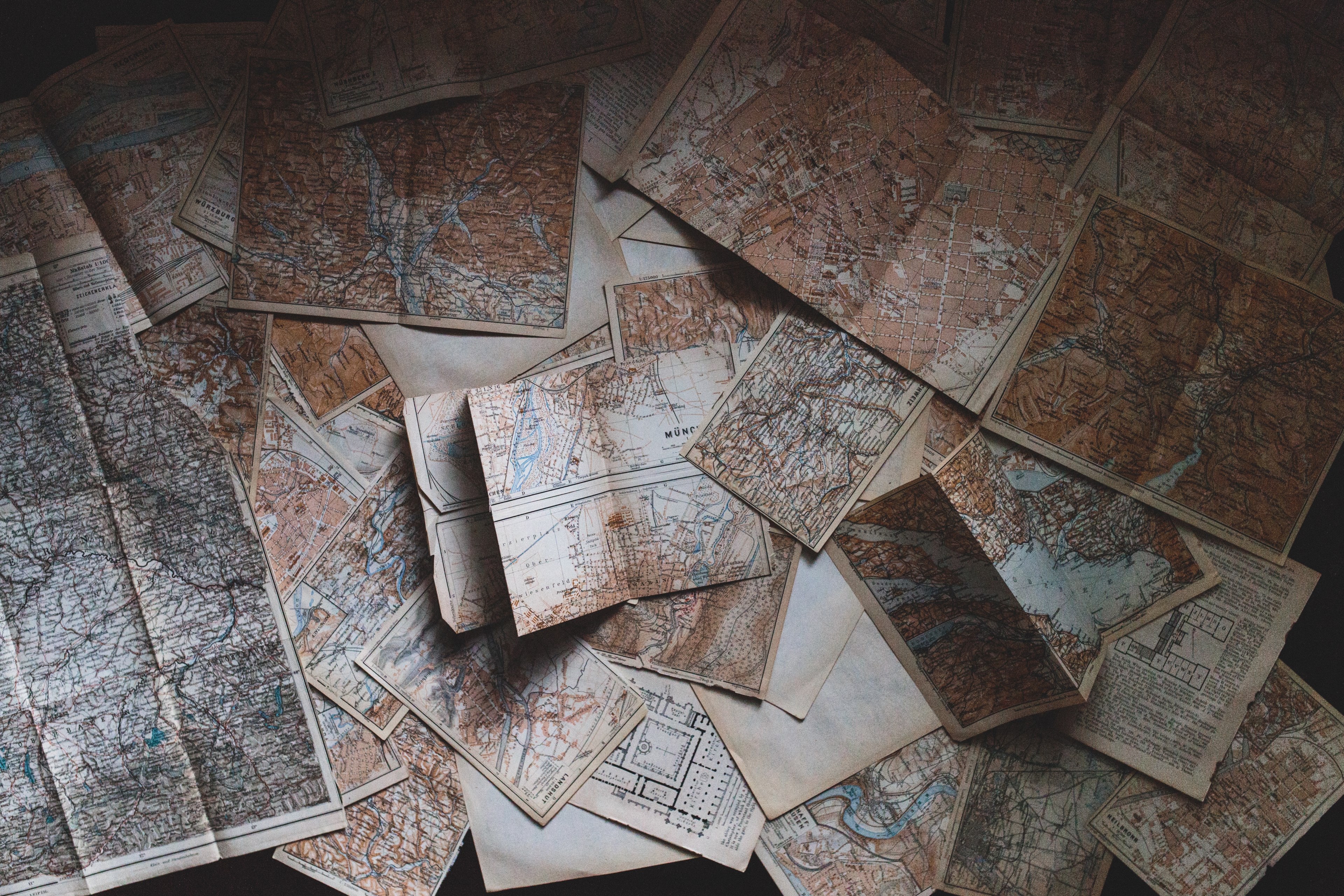 an overhead shot of a large collection of maps scattered on the floor, where to next 4k, HD Wallpaper