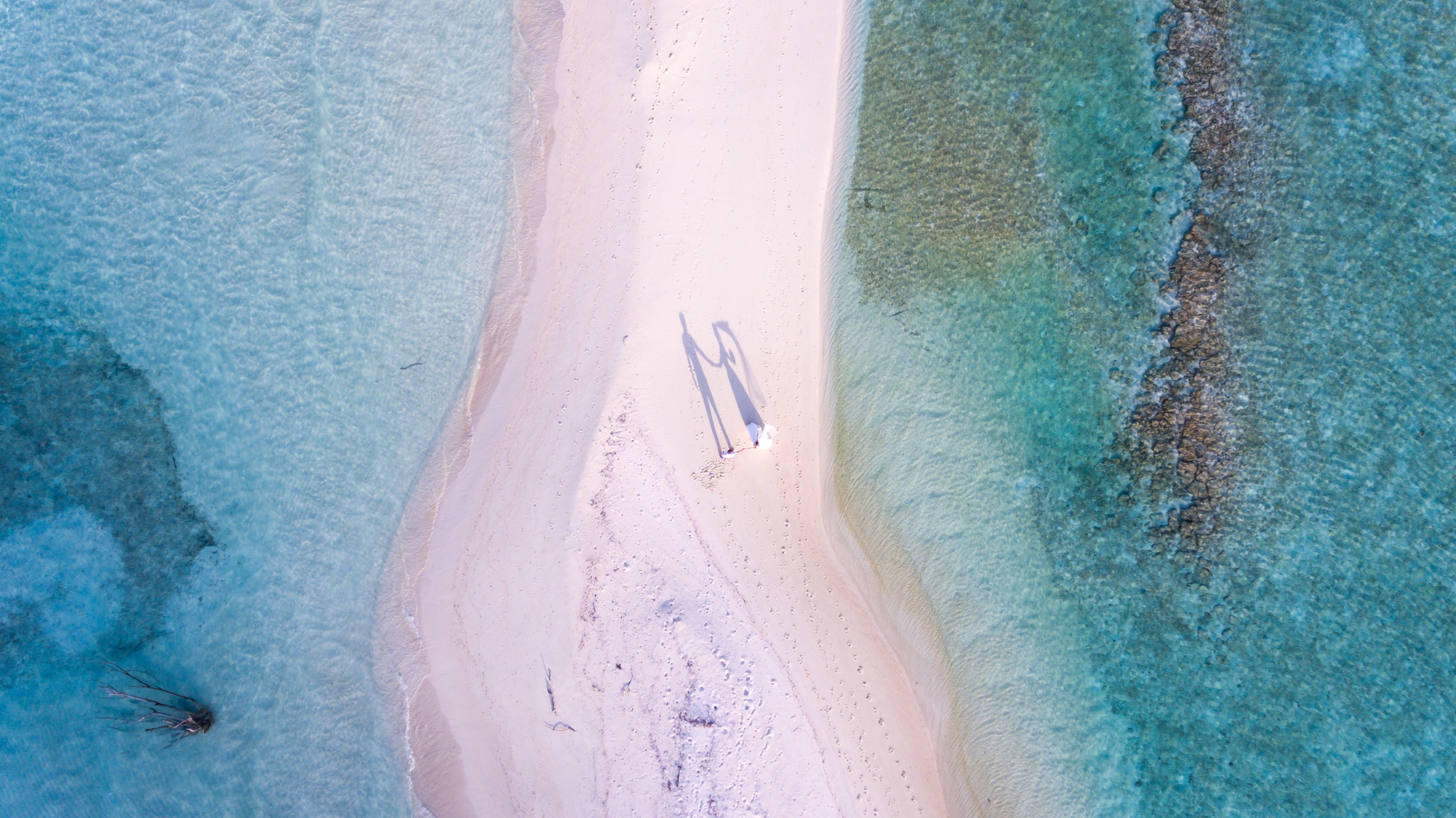 drone aerial view of newly wed couple on the sand beach stretch by the ocean at the north central province maldives, wedding photography in maldives by ishan 4k, HD Wallpaper