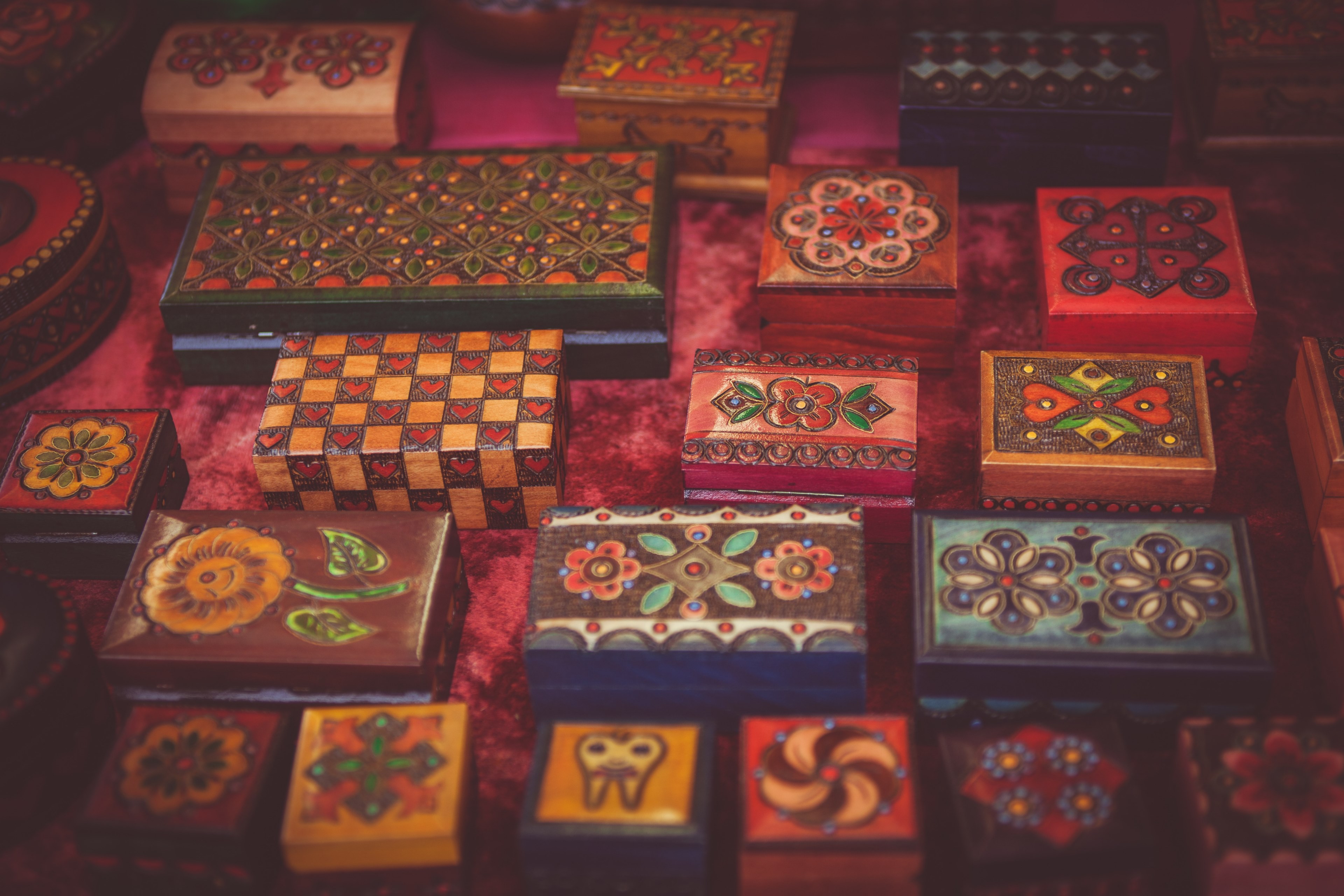 assorted woodwork boxes collection with varied floral art designs on red fabric surface in cambridge, decorated wood boxes 4k, HD Wallpaper
