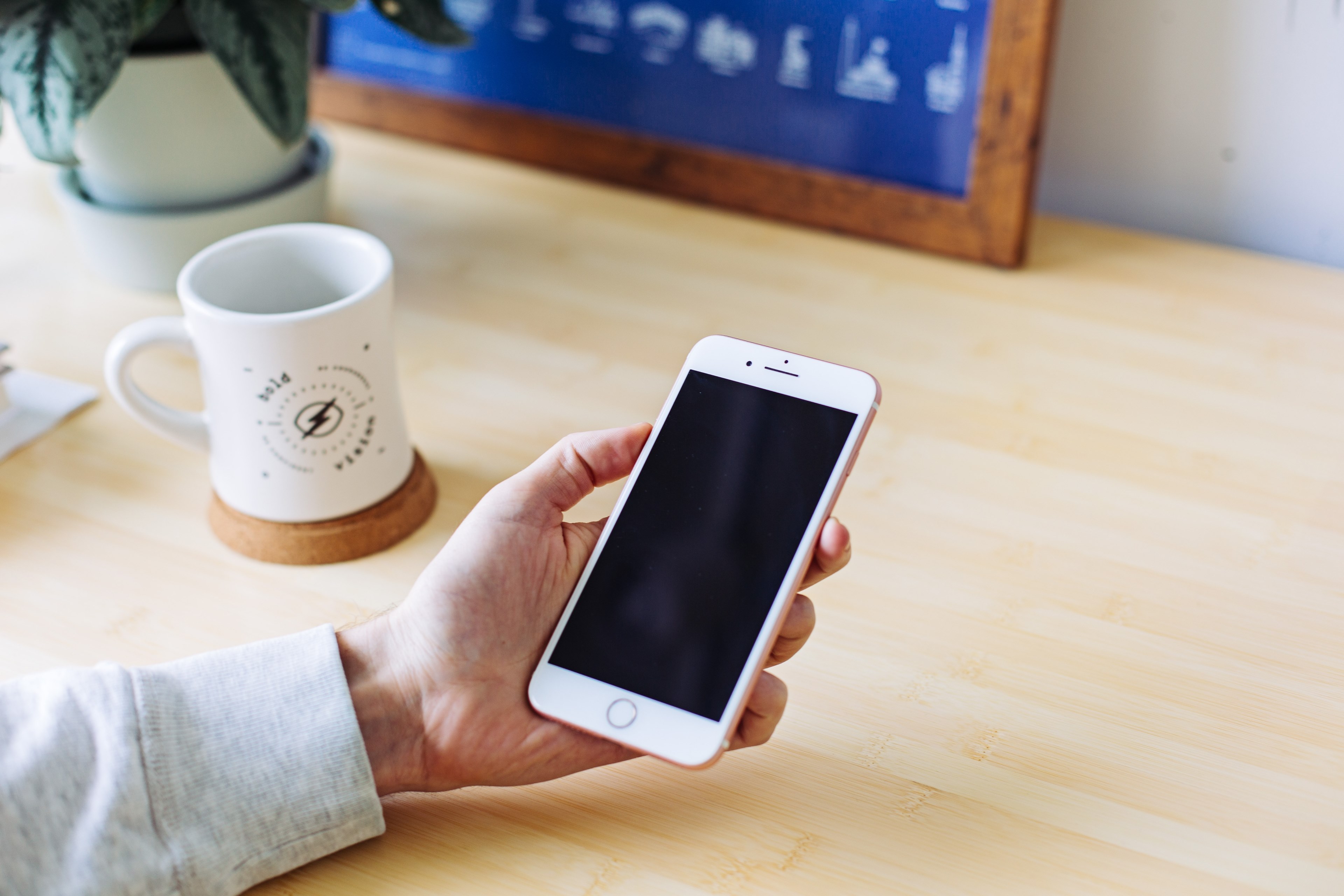 a person holding an iphone over a desk with a white mug, iphone mock scene 4k, HD Wallpaper