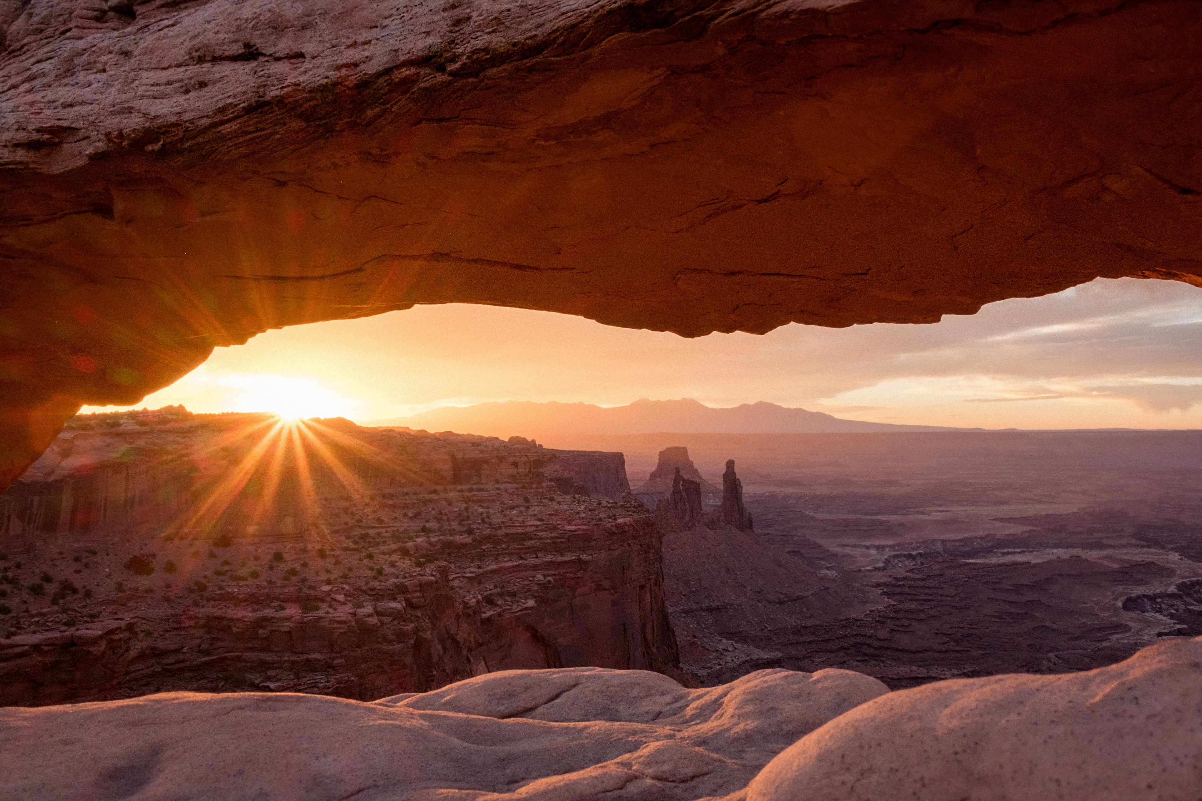 the sun with flare effect over a rock formation seen through a rock arch a valley in the distance, sunrise rock formation and valley 4k, HD Wallpaper
