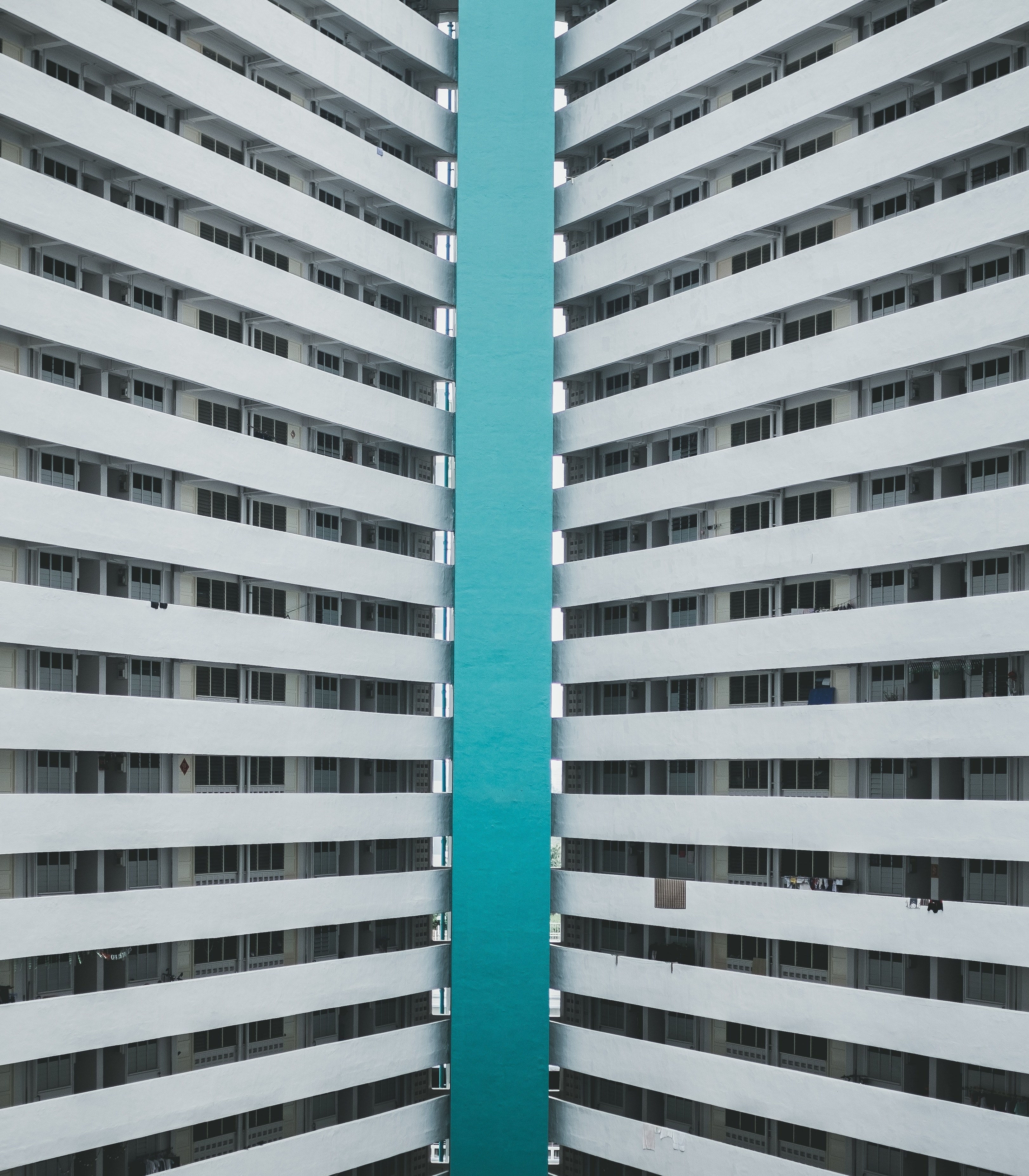 azure sea framed by twin tower blocks in singapore, sea between tower blocks 4k, Phone HD Wallpaper