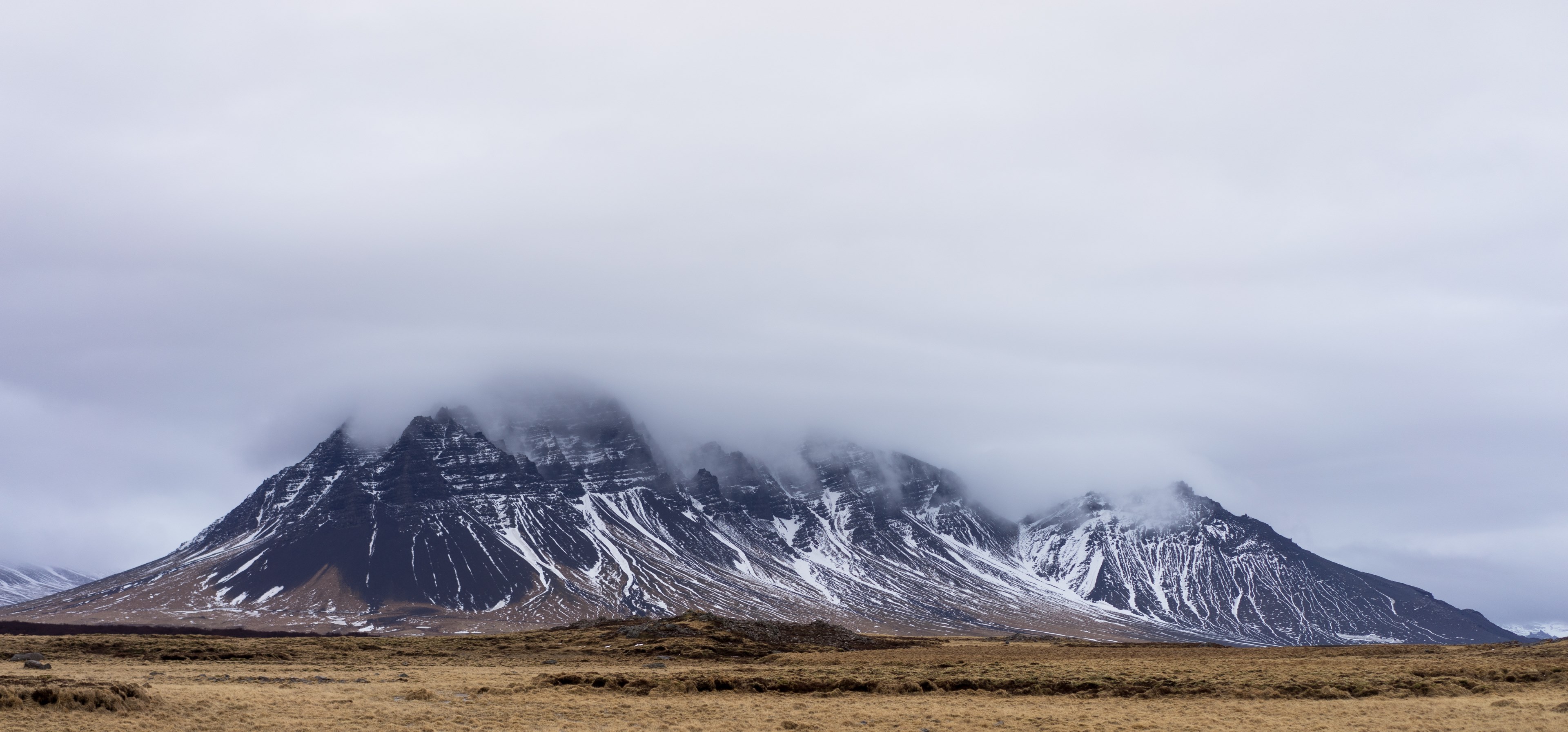 a dark granite mountain shrouded in dense mist, misty icelandic mountain 4k, HD Wallpaper