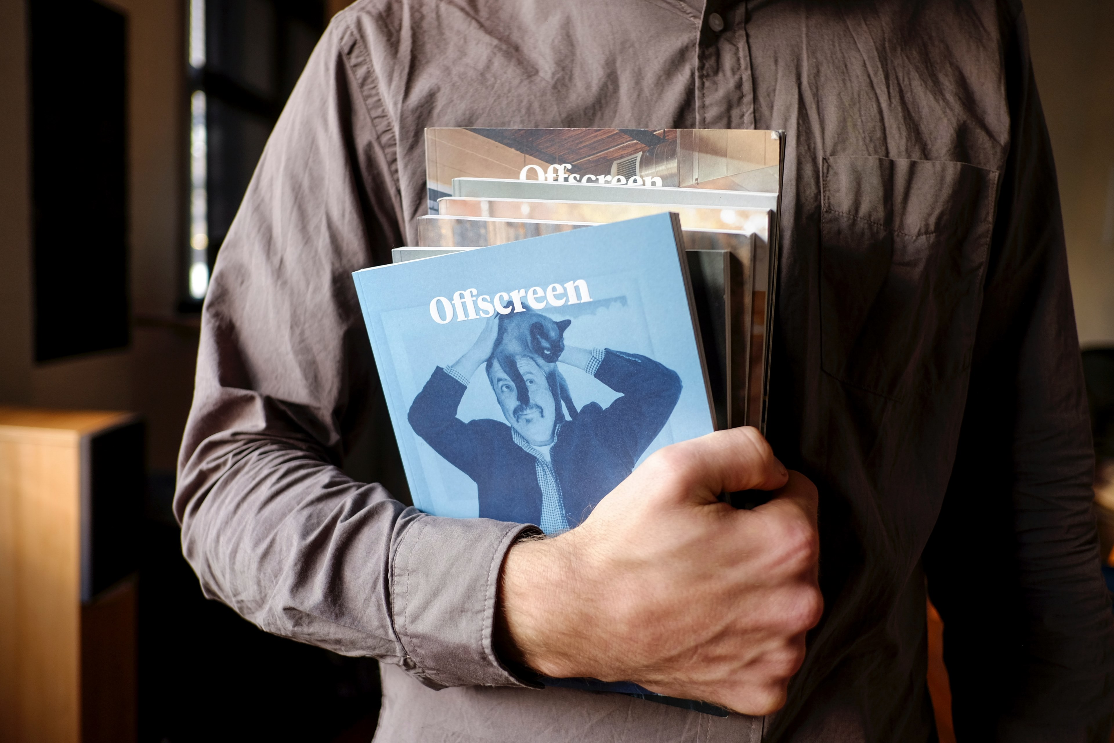 a person in a button up shirt holds a stack of offscreen magazines, stack of offscreen 4k, HD Wallpaper