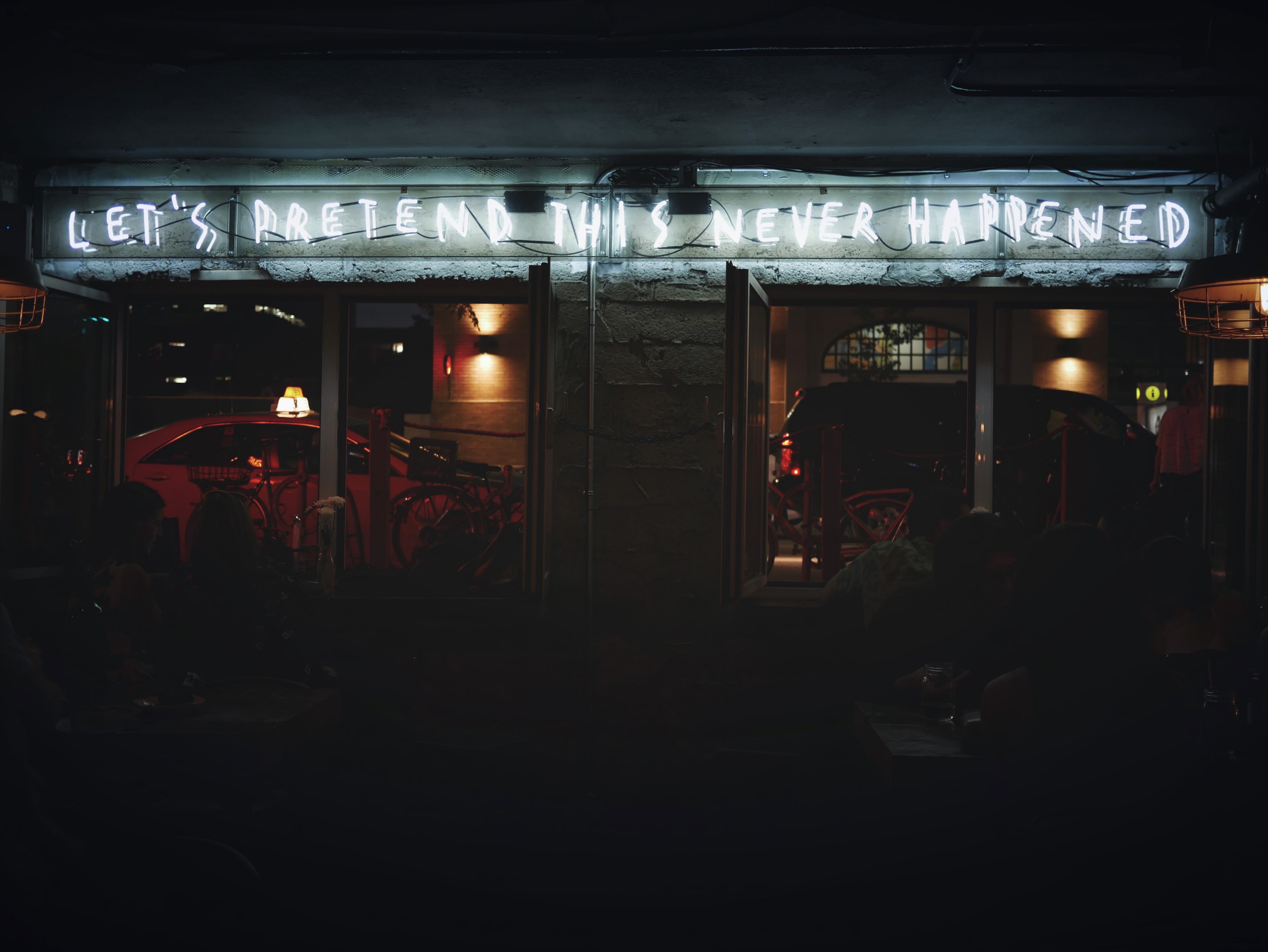 a white neon over a storefront reads lets pretend this never happenedquot, pretend this never happened 4k, HD Wallpaper