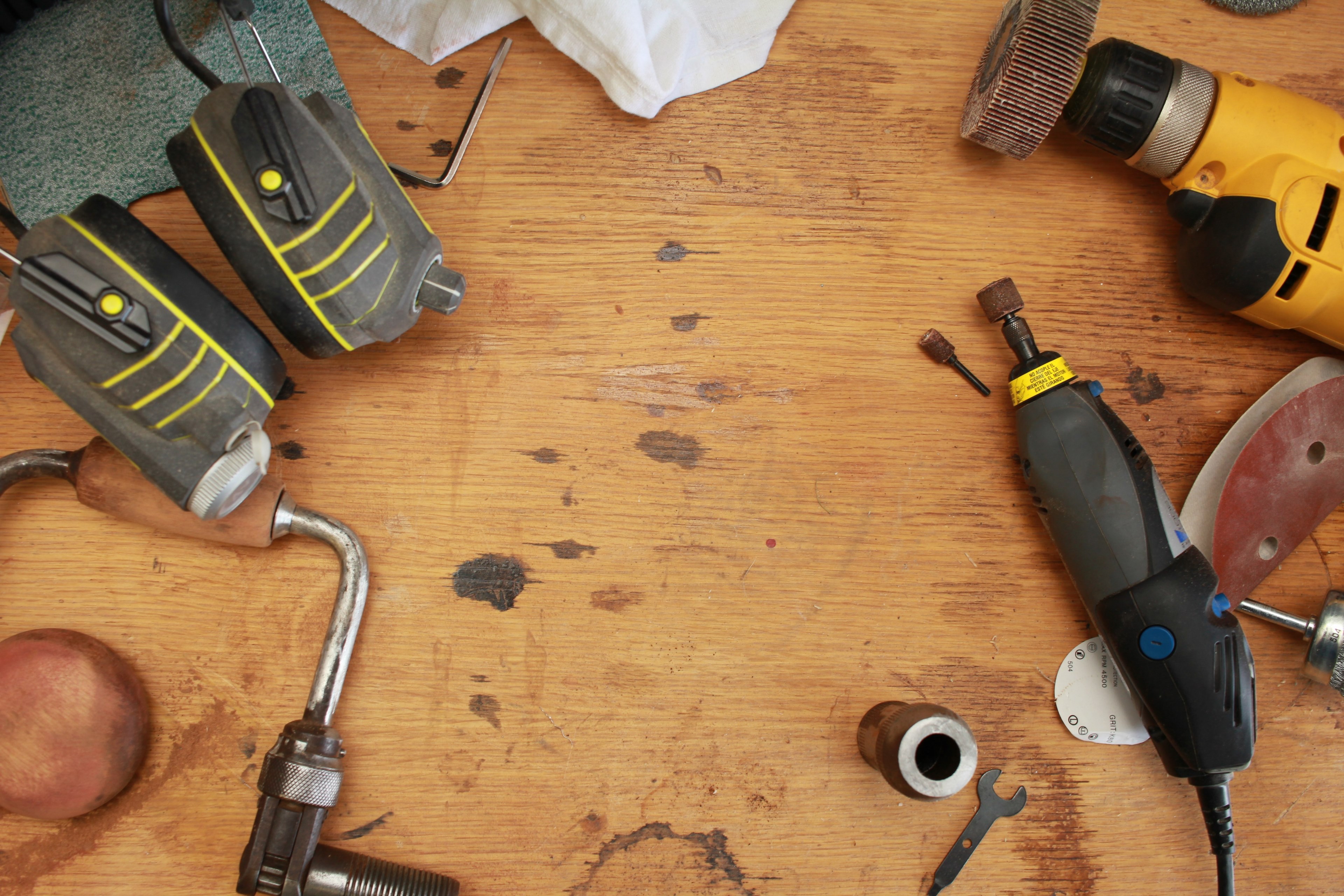 various sanding and chiseling equipment and a clamp on a wooden table marked with stains, workshop table 4k, HD Wallpaper