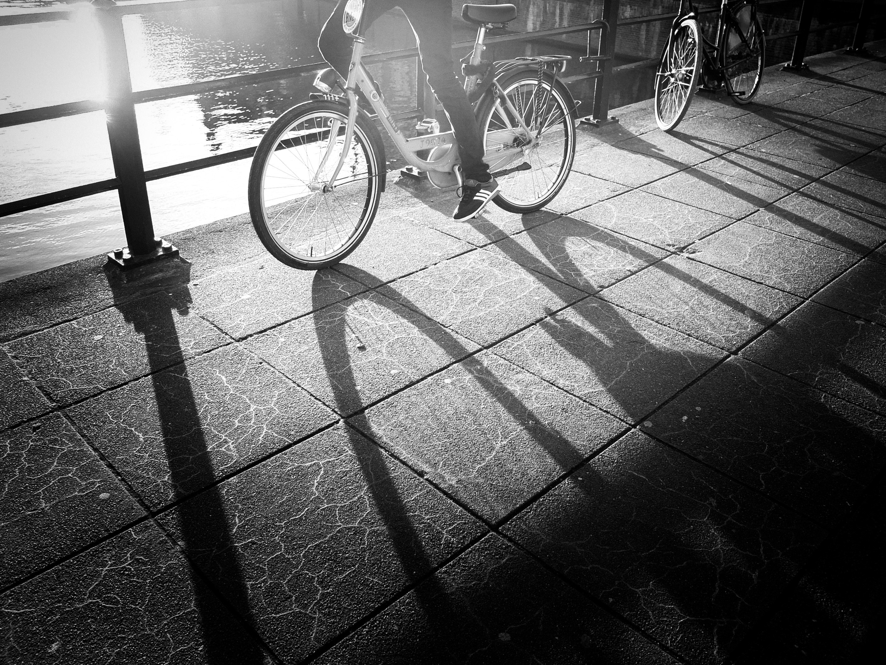 a black and white shot of a bike and its shadow in amsterdam, bikes and shadow amsterdam 4k, HD Wallpaper