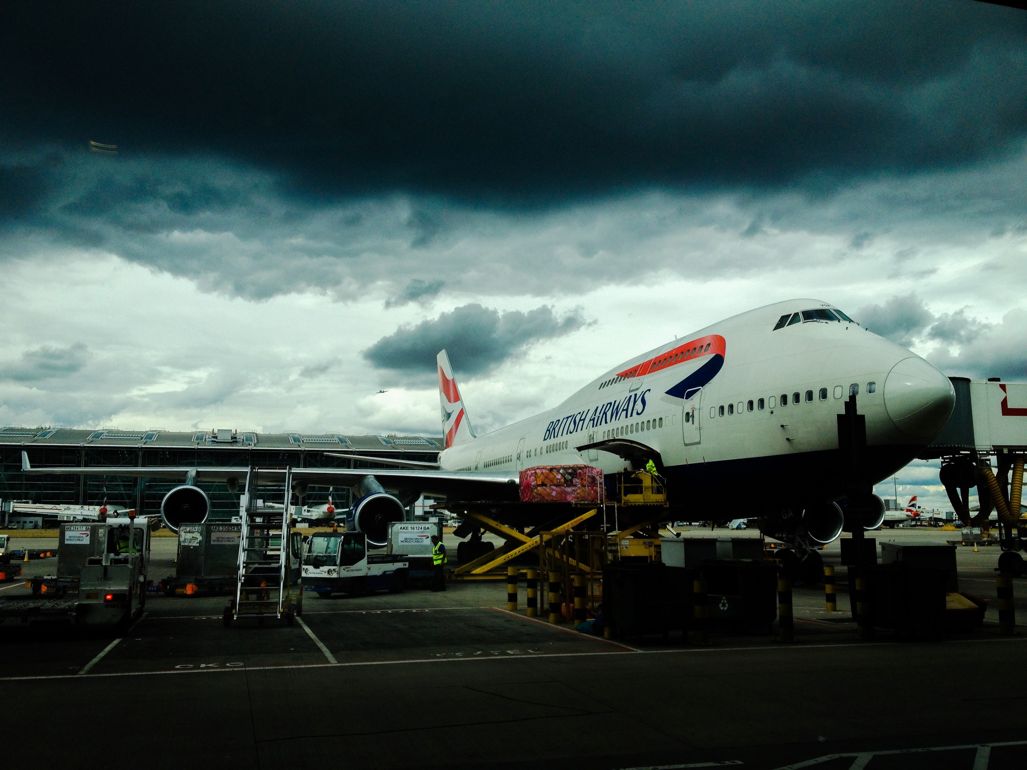 british airways airplane on the ground of an airport under dark cloudy skies, airplane under dark cloudy skies 4k, HD Wallpaper