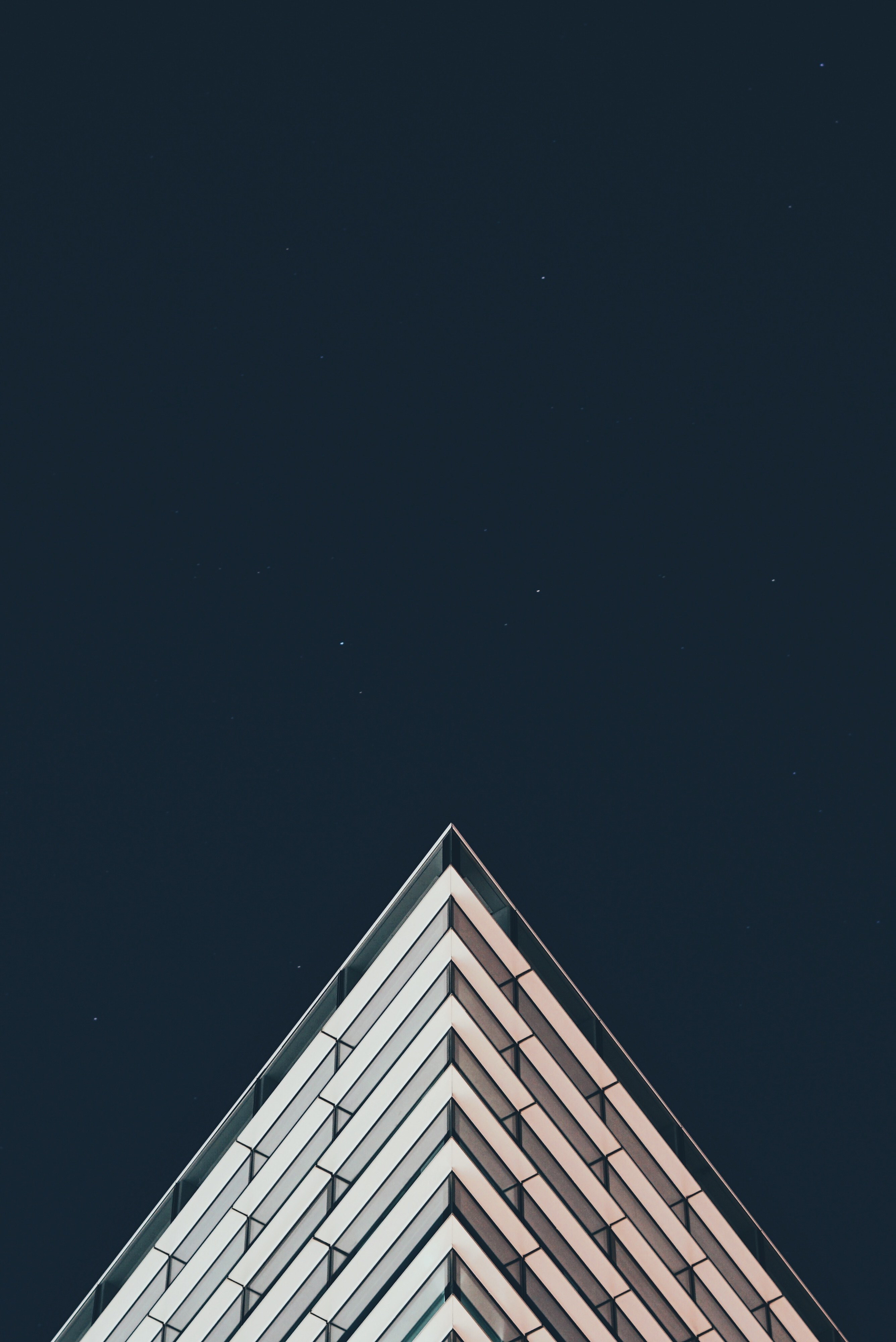 the sharp top corner of a modern building seen against the night sky, is this real 4k, Phone HD Wallpaper