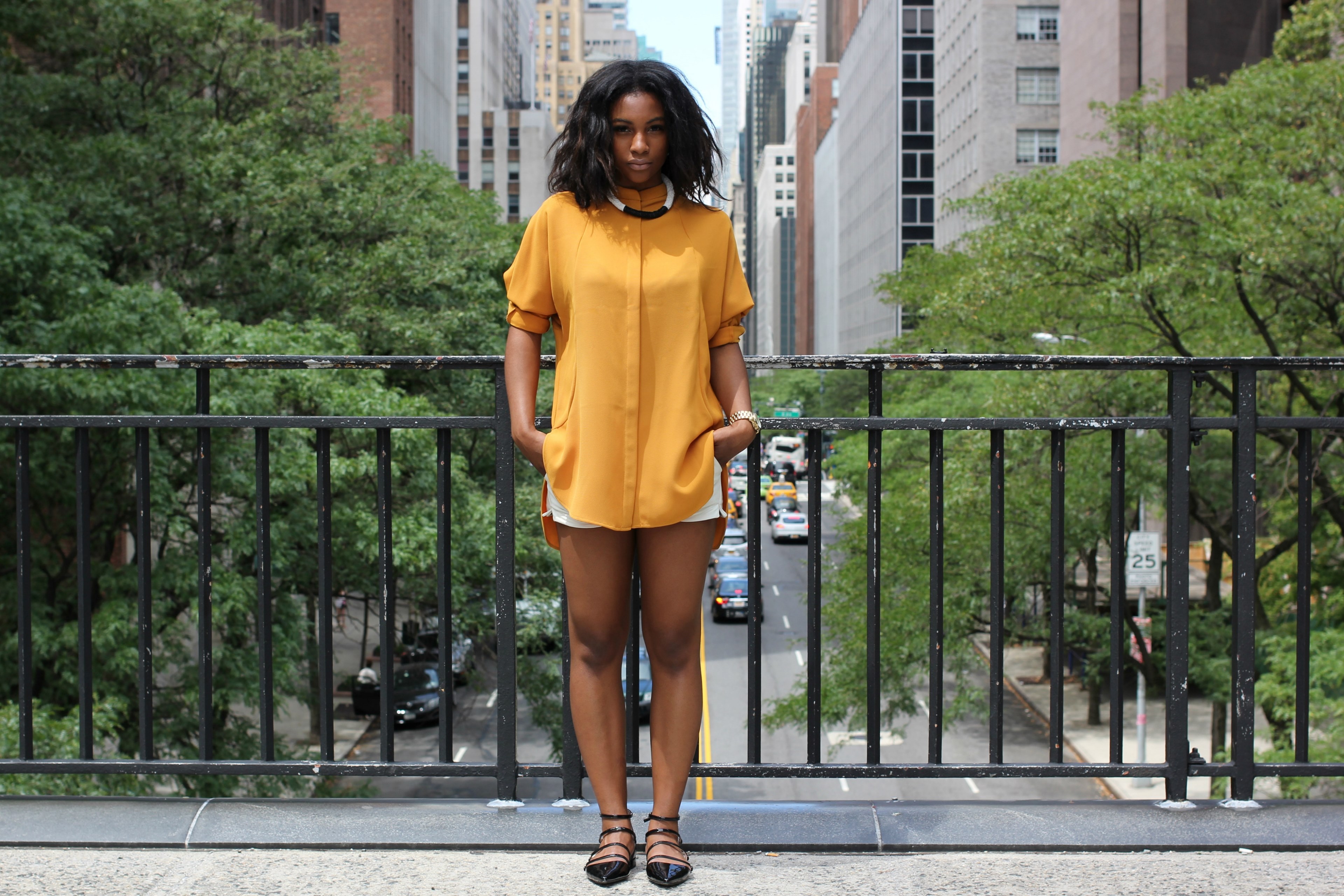 woman models a yellow shirt and shorts on a bridge in new york, new york street fashion 4k, HD Wallpaper