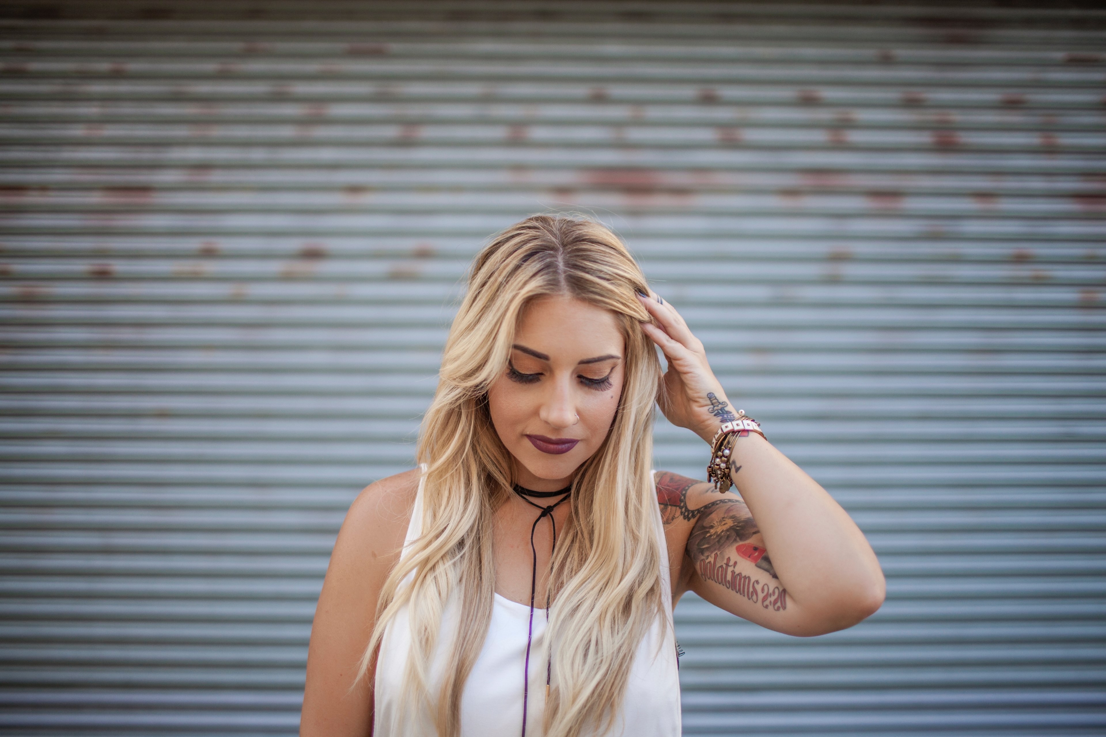 happy woman with a tattoo fixes her hair and looks down, cassandra 4k, HD Wallpaper