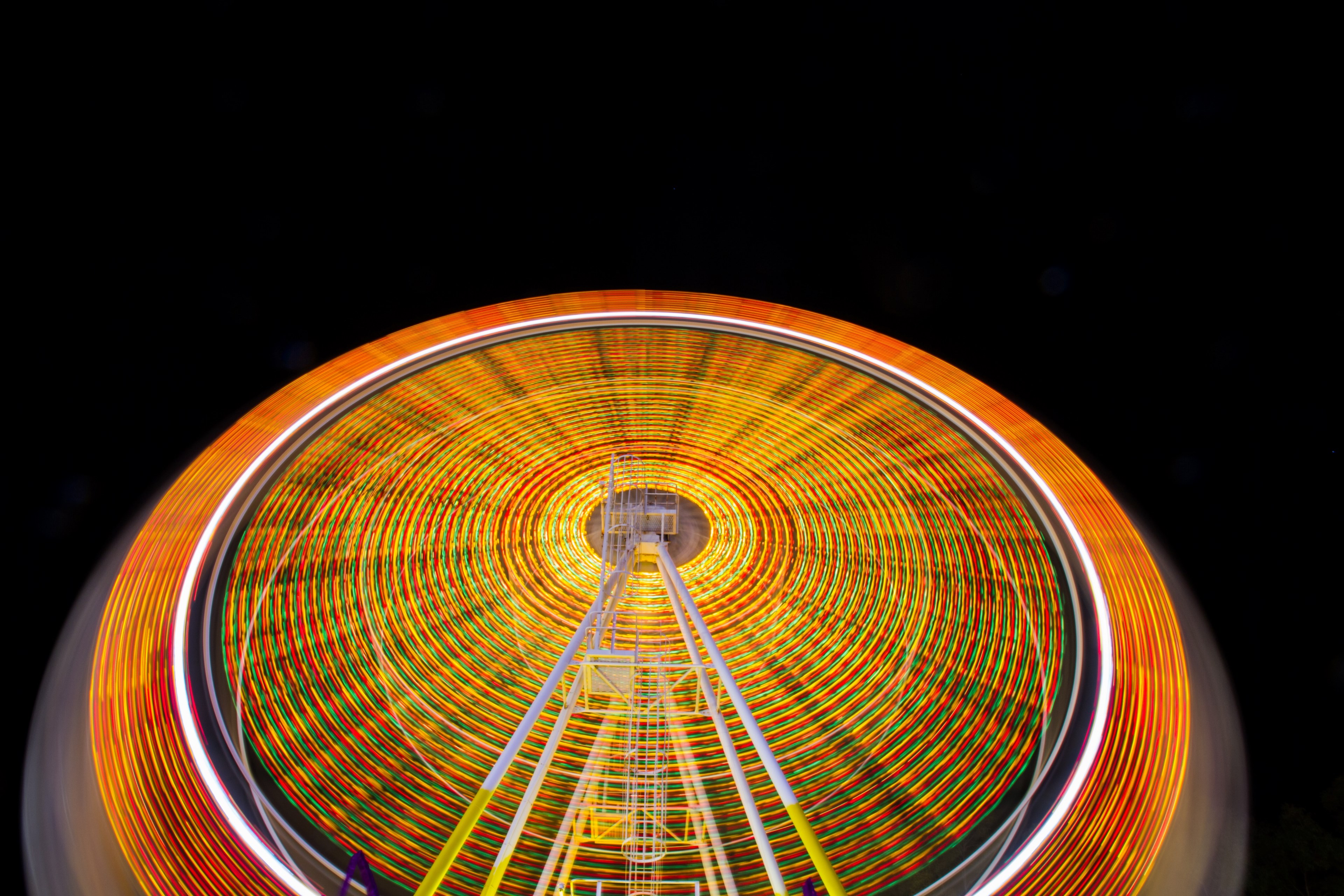 a time exposure shot of a ferris wheel with vivid orange and yellow light trails, orange and yellow ferris wheel light trails 4k, HD Wallpaper