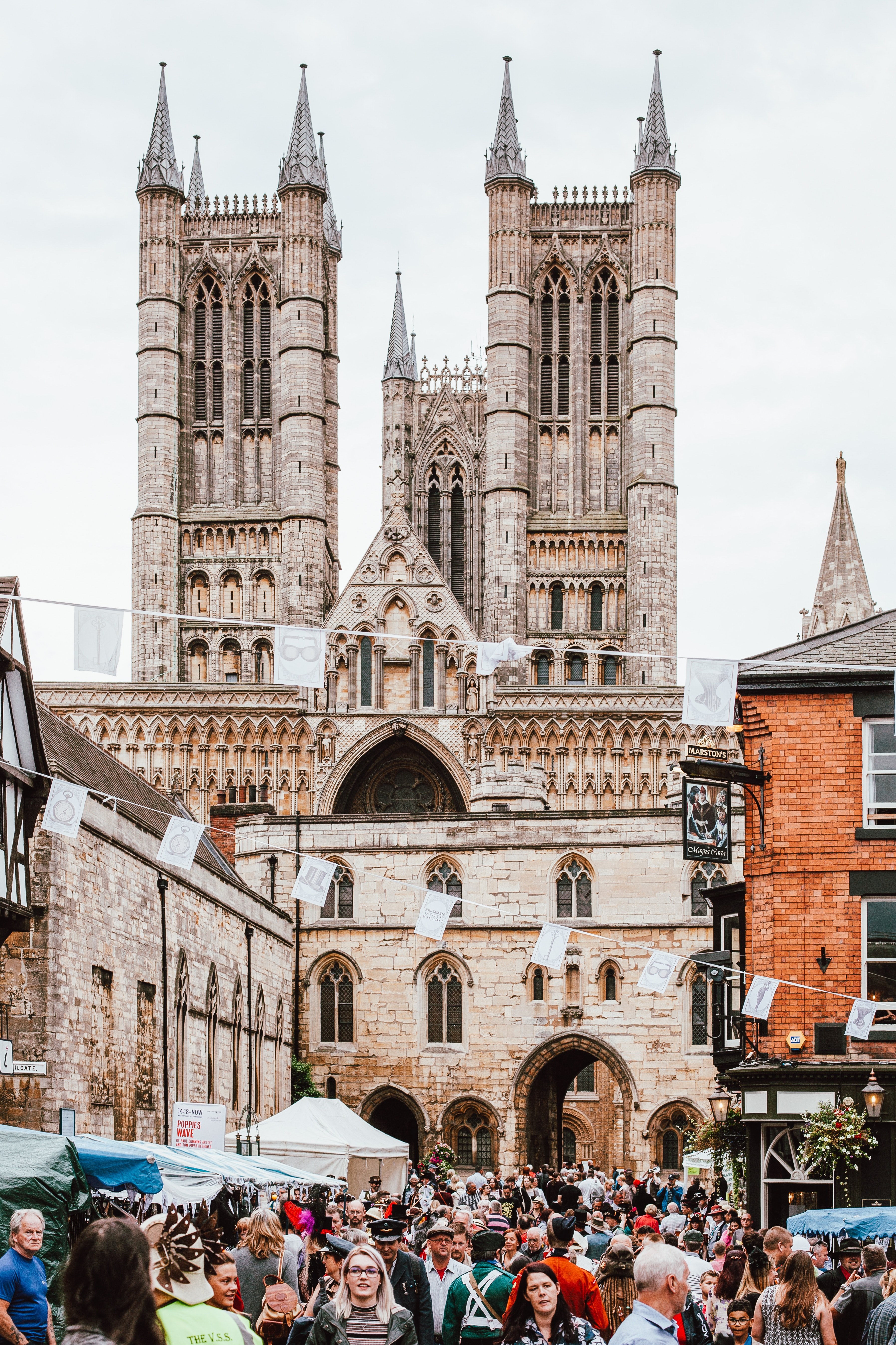 the streets filled with people in front of a cathedral church in lincoln, crowd in front of a church_ 4k, Phone HD Wallpaper