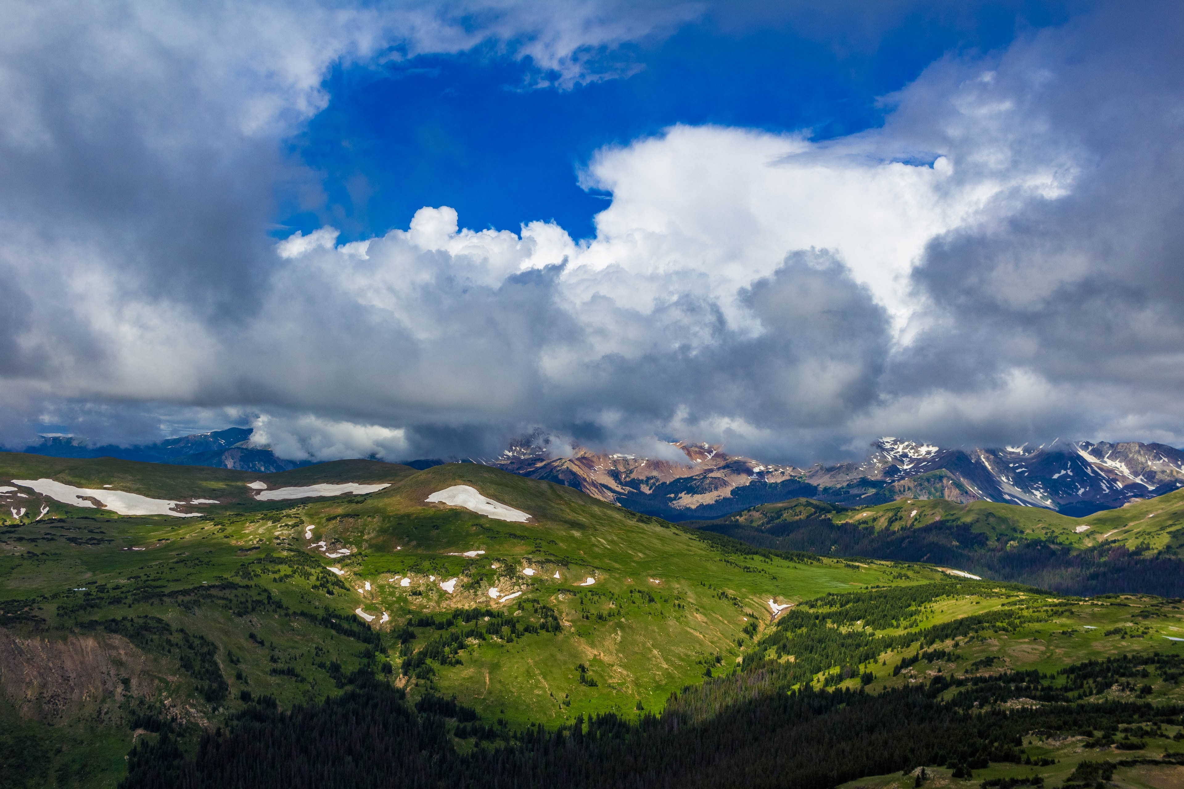 clear sky with big fluffy clouds covering a lush green mountain with snow patches on trail ridge road summit, _snow patches on mountains 4k, HD Wallpaper