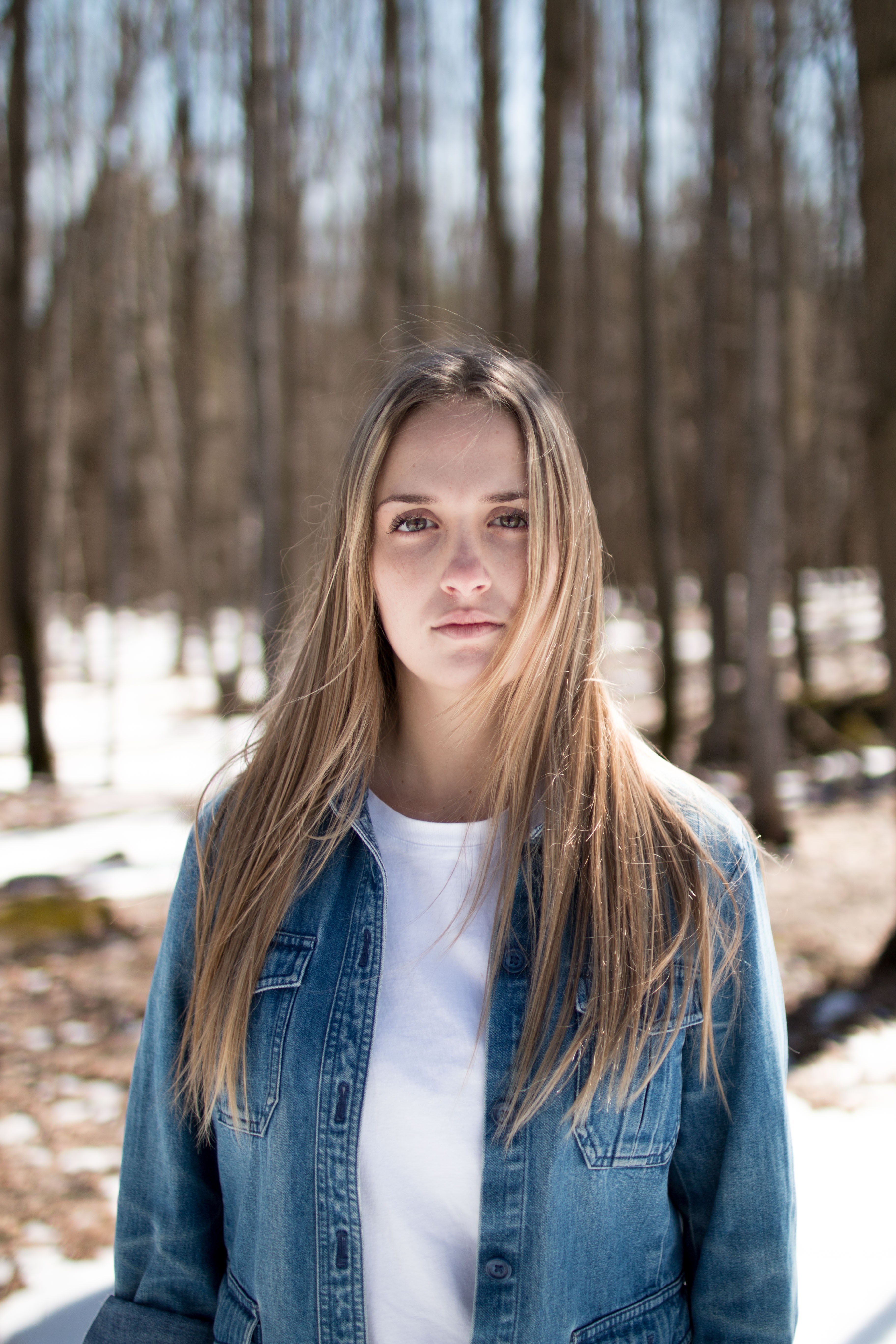 a girl wearing a denim jacket standing in the woods in georgeville, georgeville girl 4k, Phone HD Wallpaper