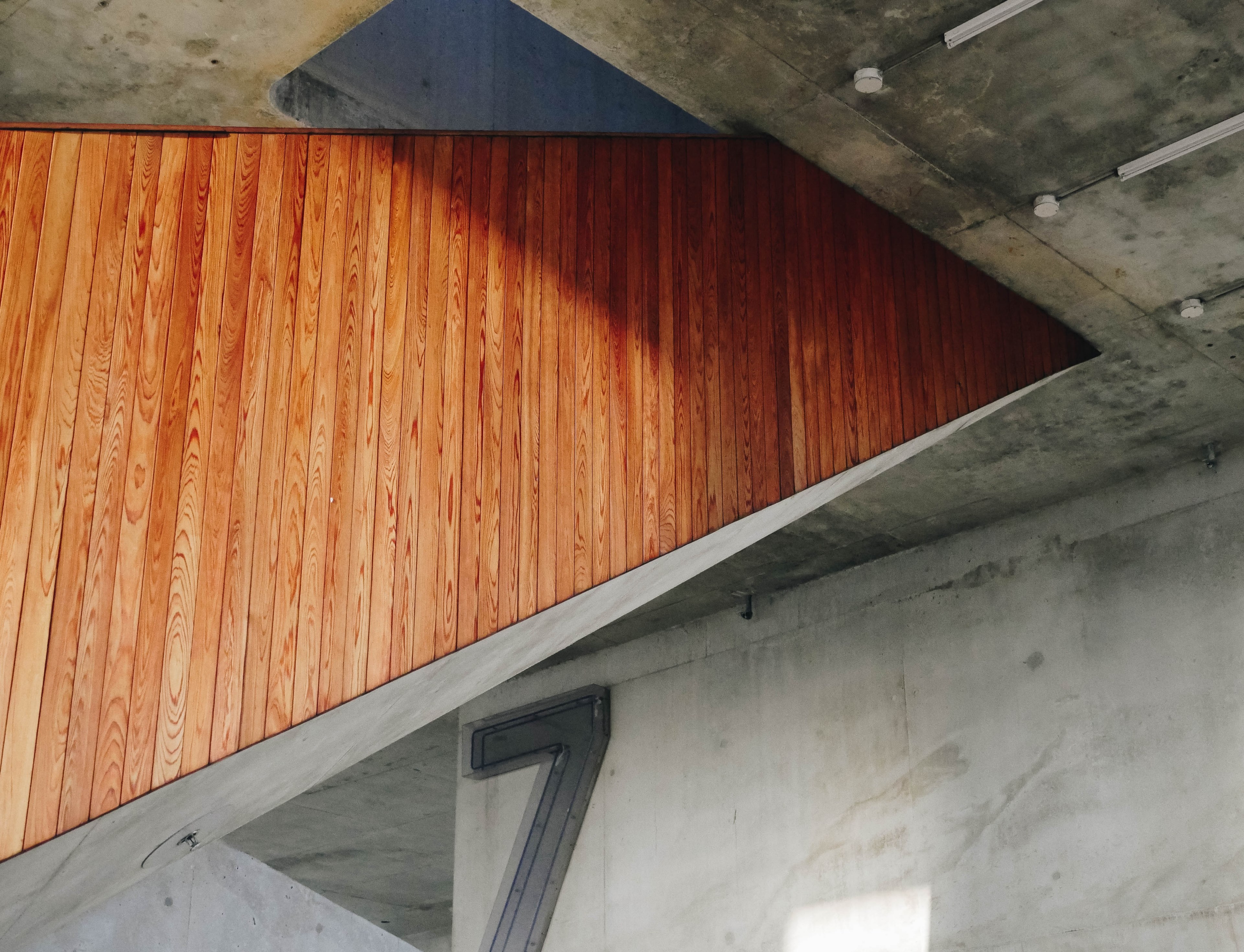 wooden panelling on the side of a staircase in a building with bare concrete walls, wooden staircase panelling 4k, HD Wallpaper
