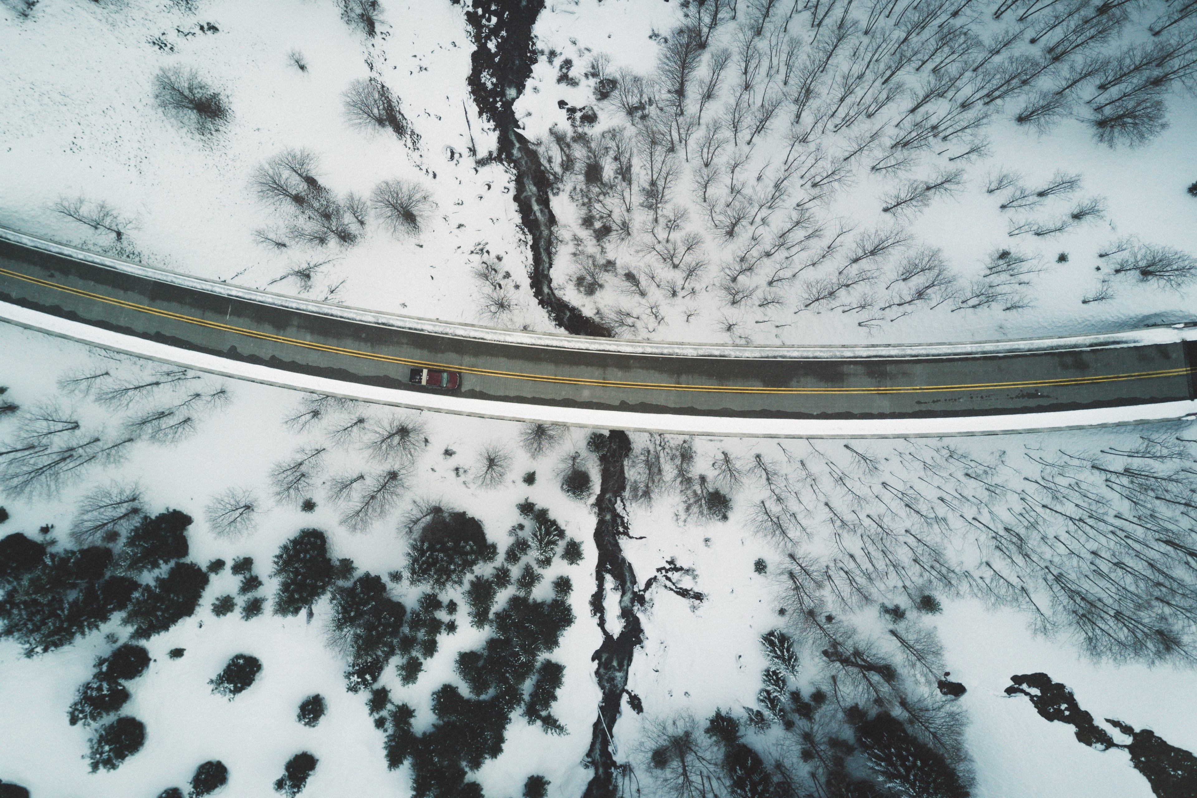 drone shot of a car driving along a bend in a road in the winter, blast zone 4k, HD Wallpaper