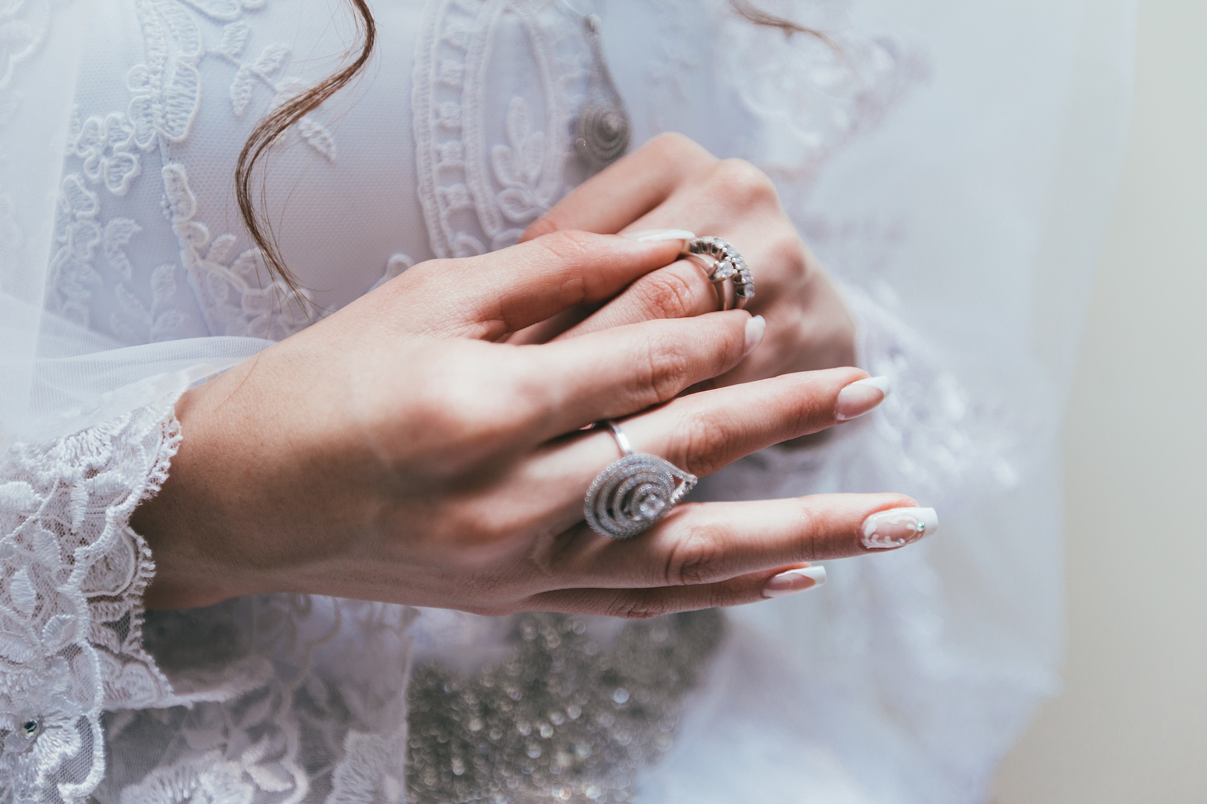 texas bride touches her wedding ring on finger in front of white lace wedding dress, 32 4k, HD Wallpaper
