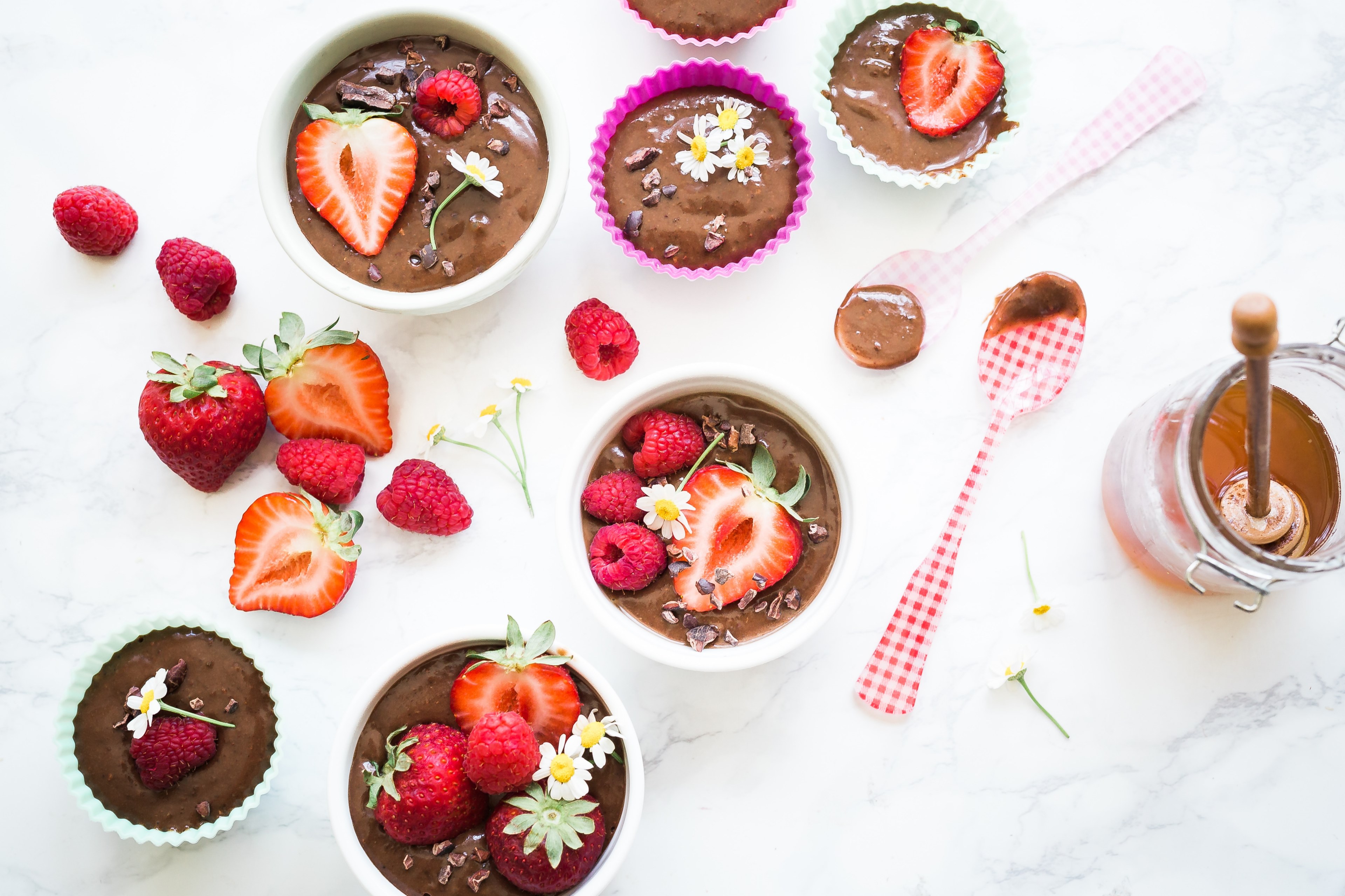 cupcake filters and bowls filled with chocolate mixture chocolate pieces strawberries raspberries and daisies beside half dipped plastic spoons and a honey jar, cravings 4k, HD Wallpaper