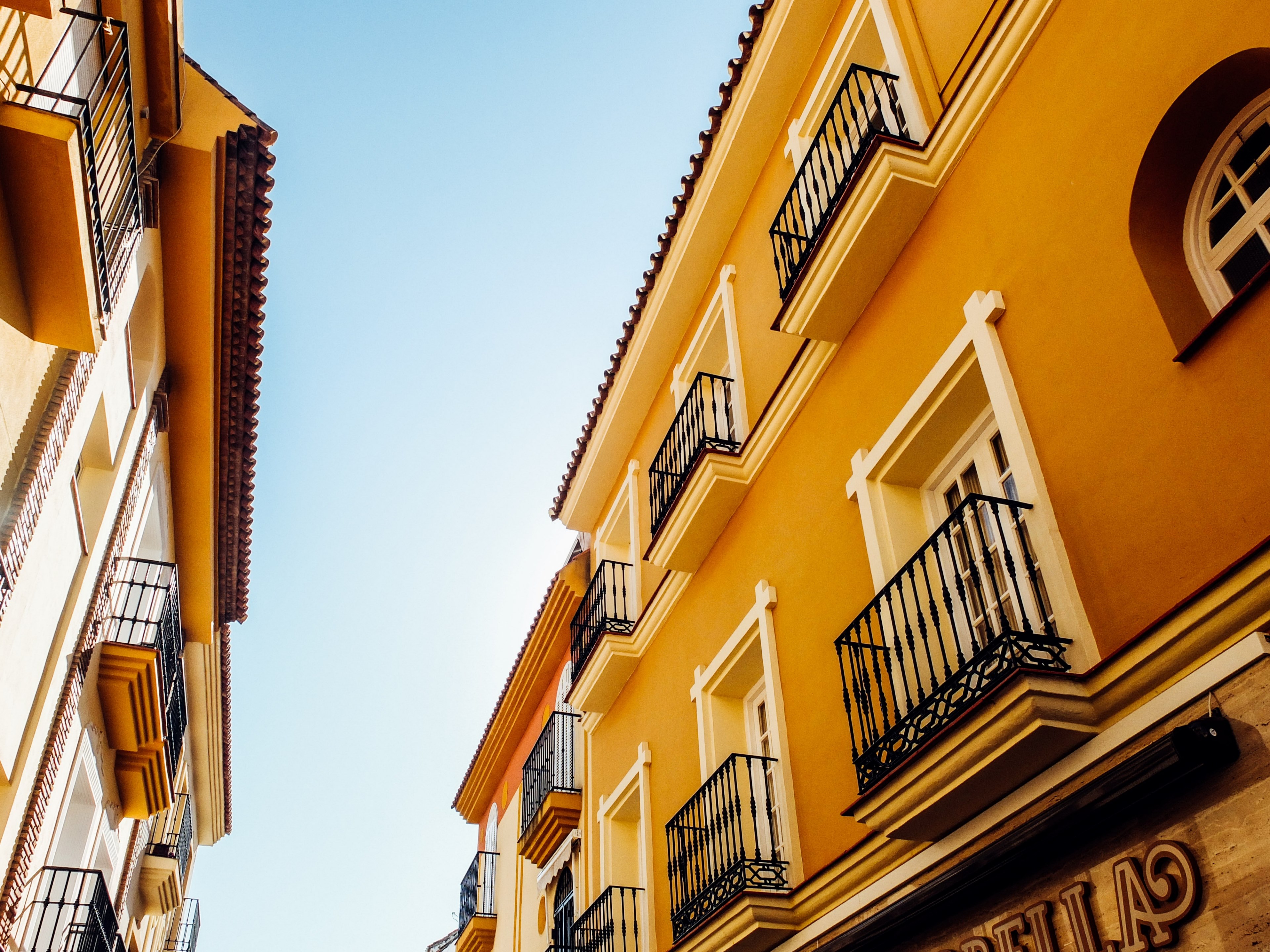 an alley with two elegant yellow buildings on its two sides in mlaga, spanish alley 4k, HD Wallpaper