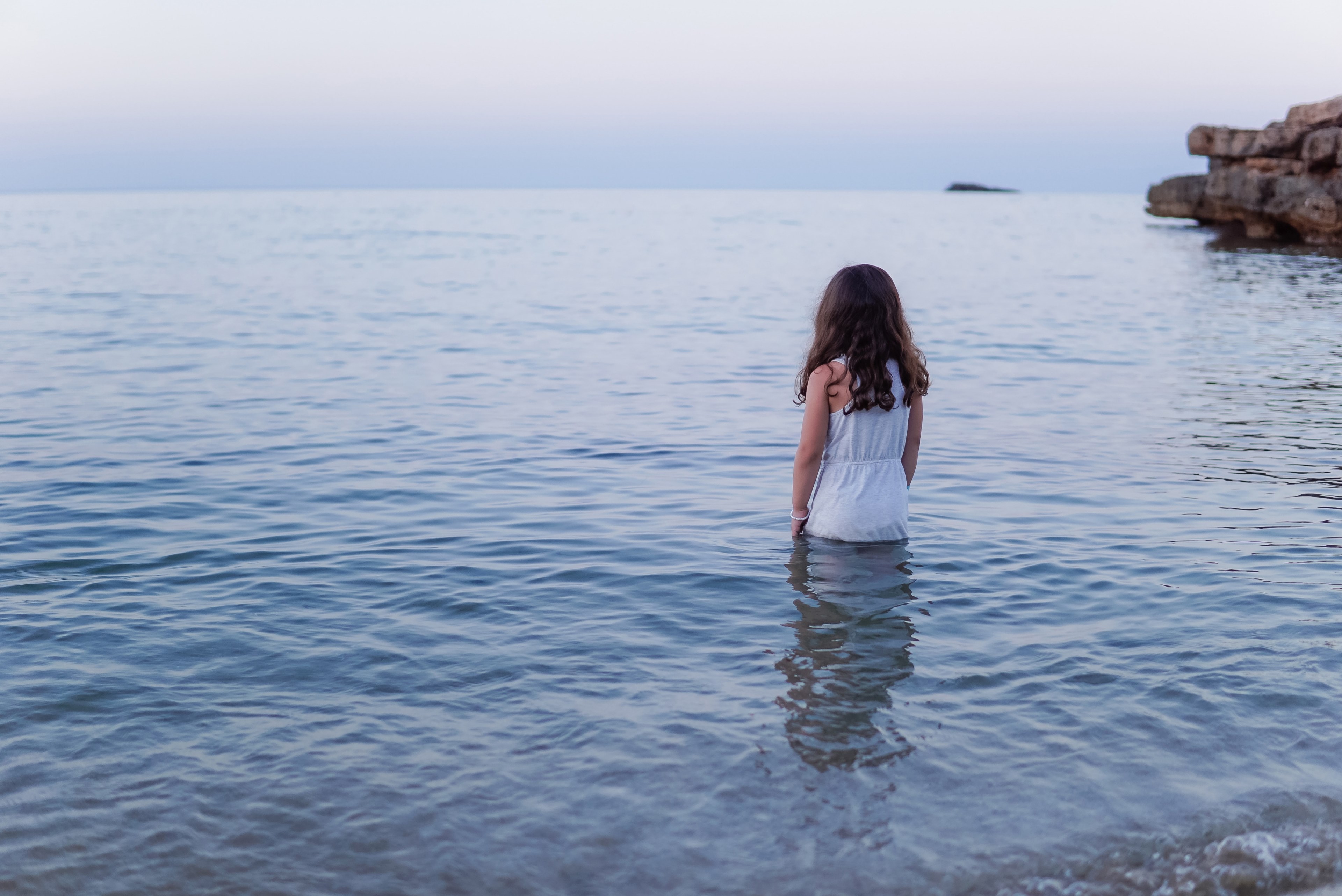 woman in white dress standing by the waist in the ocean in es figueral, woman standing in ocean 4k, HD Wallpaper