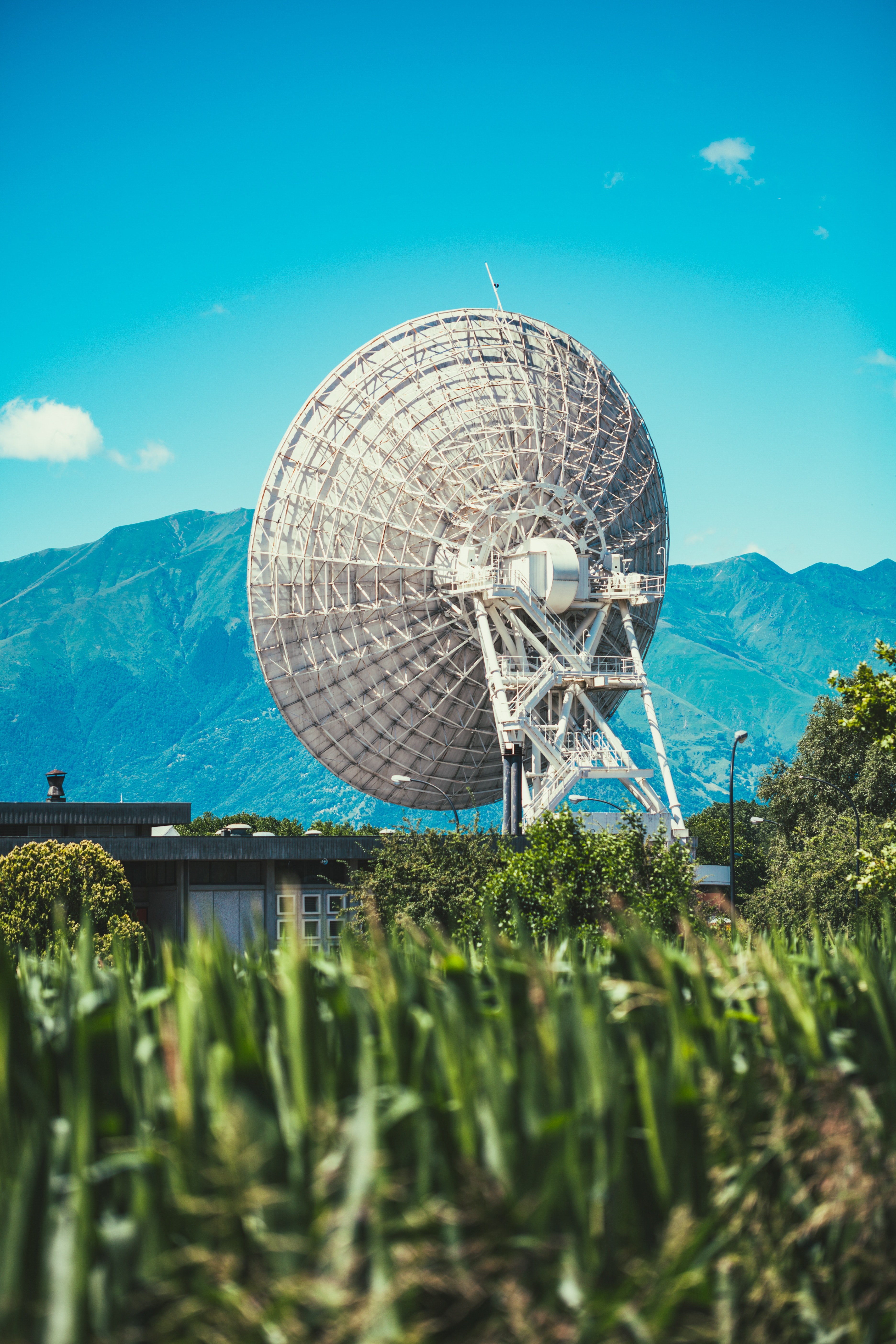 communication satellite in a grassy field near the mountains, sending signals 4k, Phone HD Wallpaper